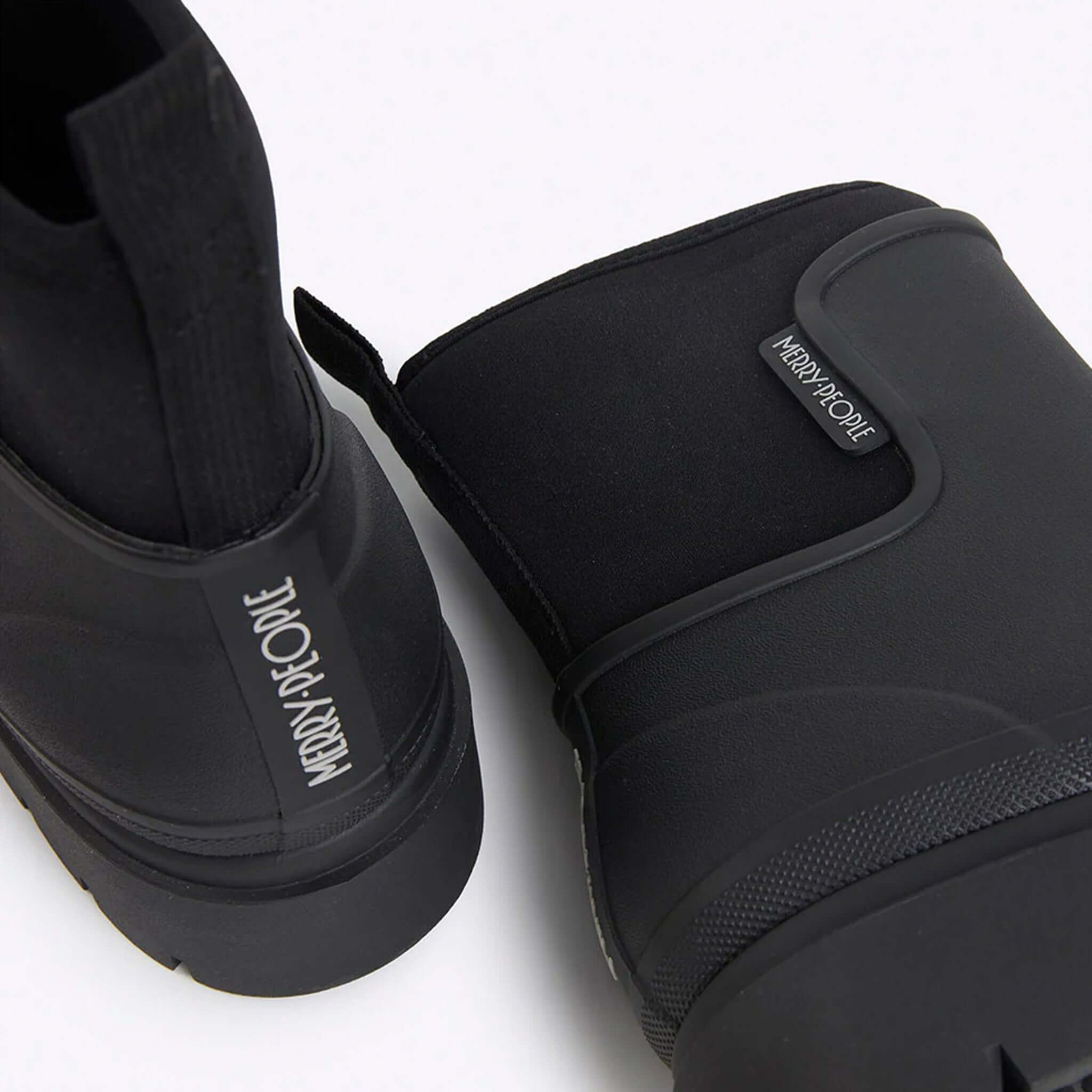 Alt Tag: Merry People Tully Boots - Black waterproof vegan rubber gumboots with neoprene cuff and chunky platform sole, close-up