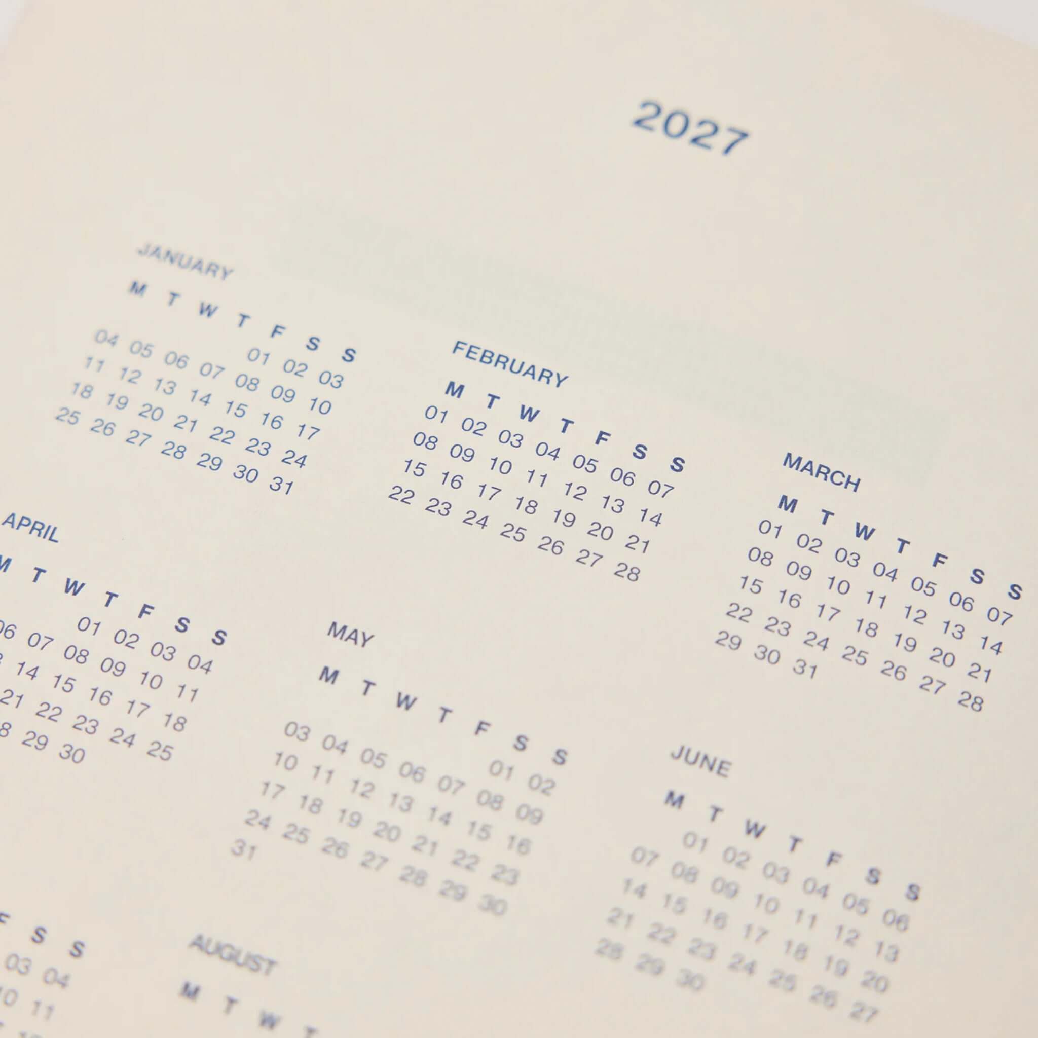 Milligram Any Day Now 2027 Weekly Achiever - Red & Pink calendar spread for 2027 month overview.