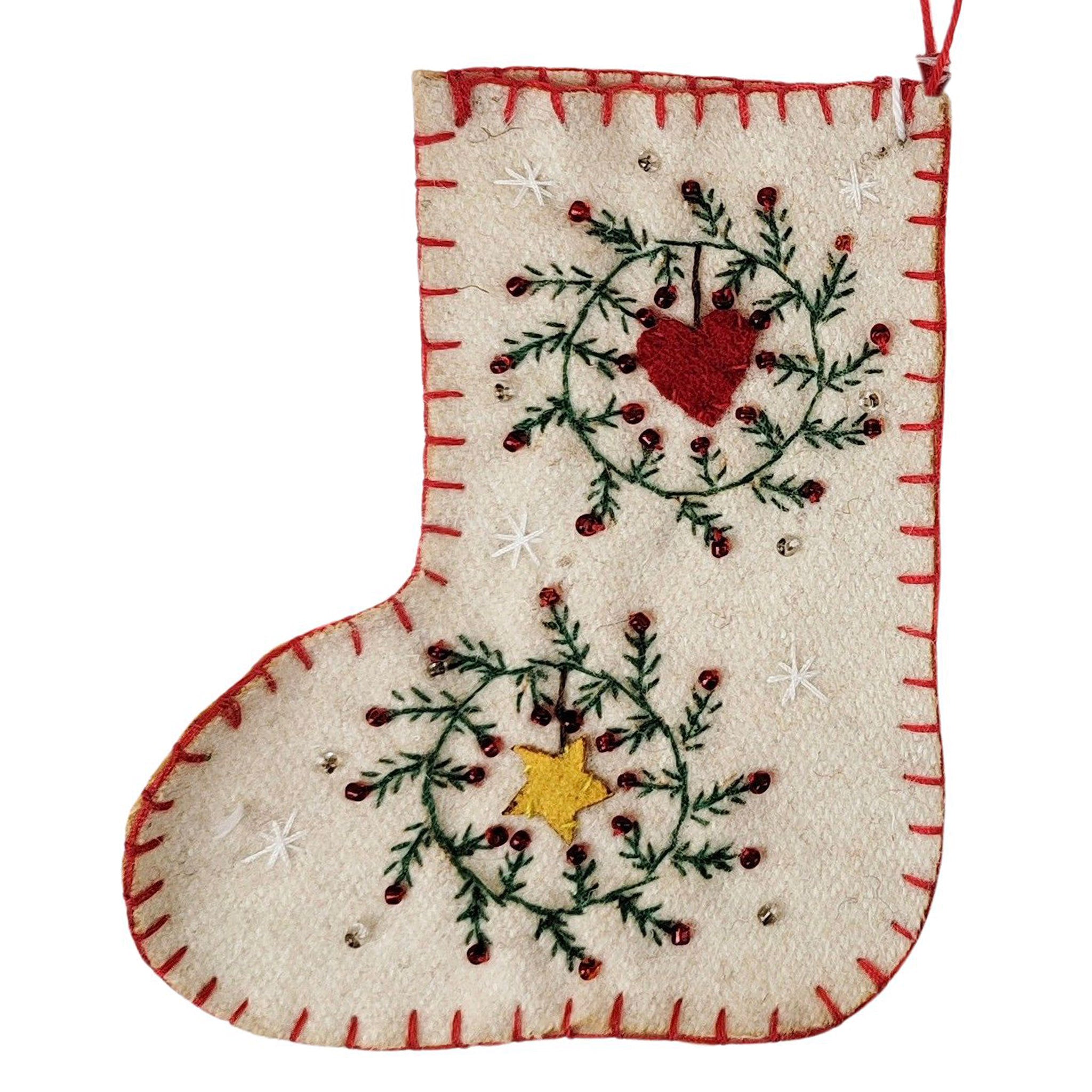 Decorative Christmas stocking with embroidered design on a white background