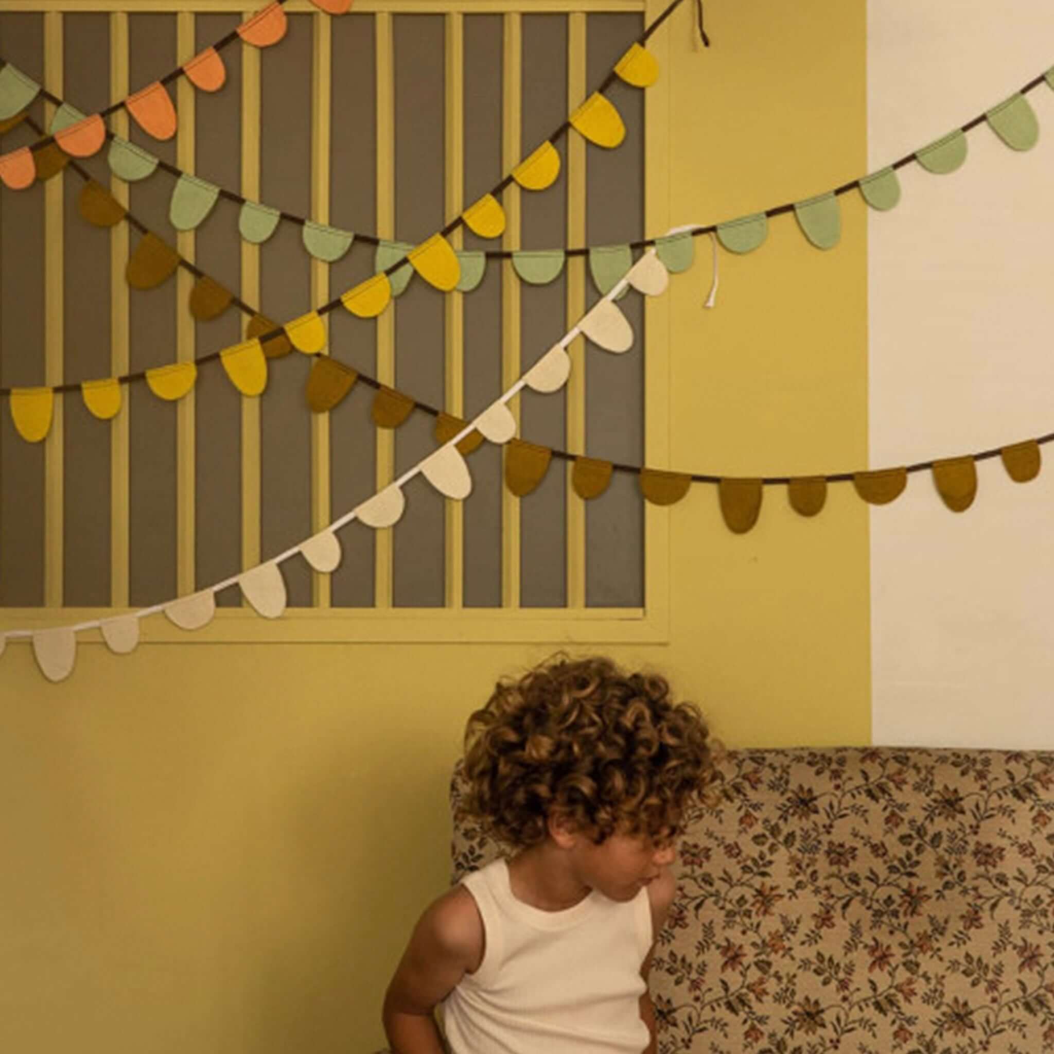 Muskhane Felt Round Flag Garland - Mint decorating a playful room with soft, colorful felt rounds.