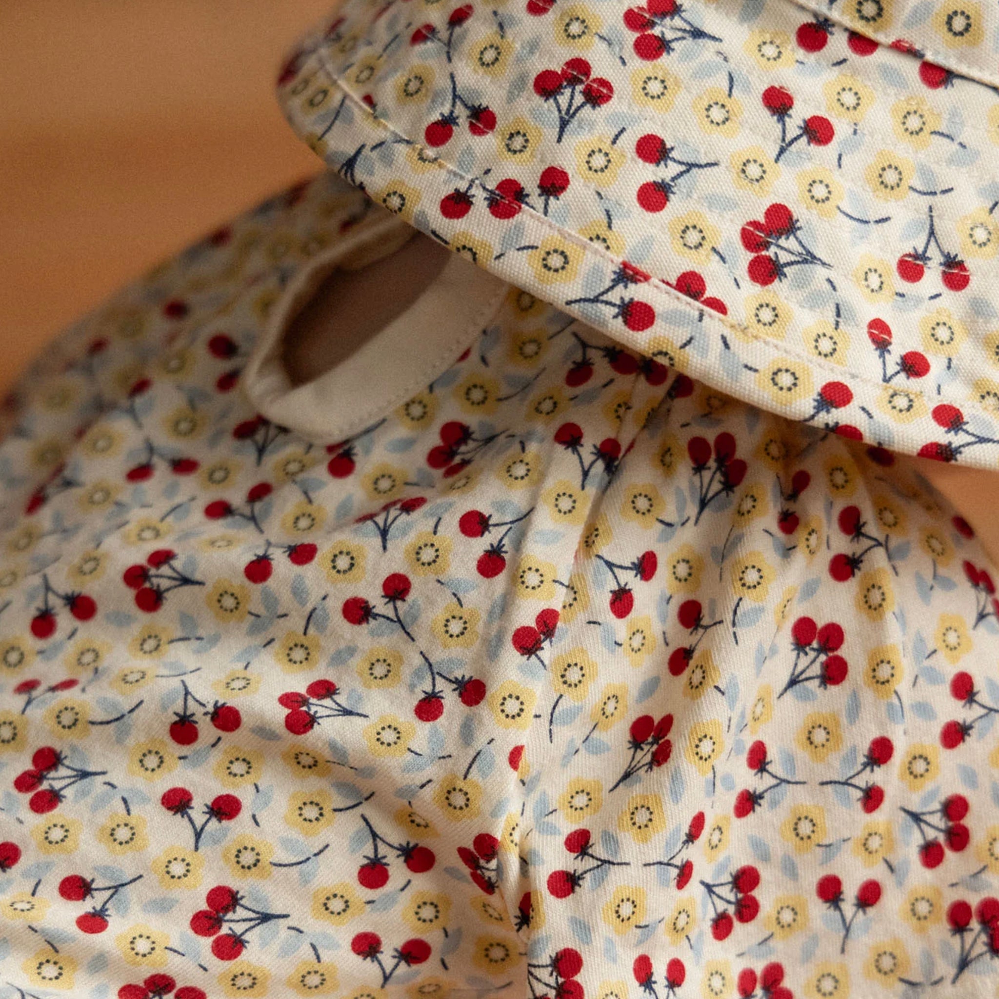 Nature Baby Organic Cotton Faye Bodysuit - Kitchen Garden featuring a cherry and daisy print.