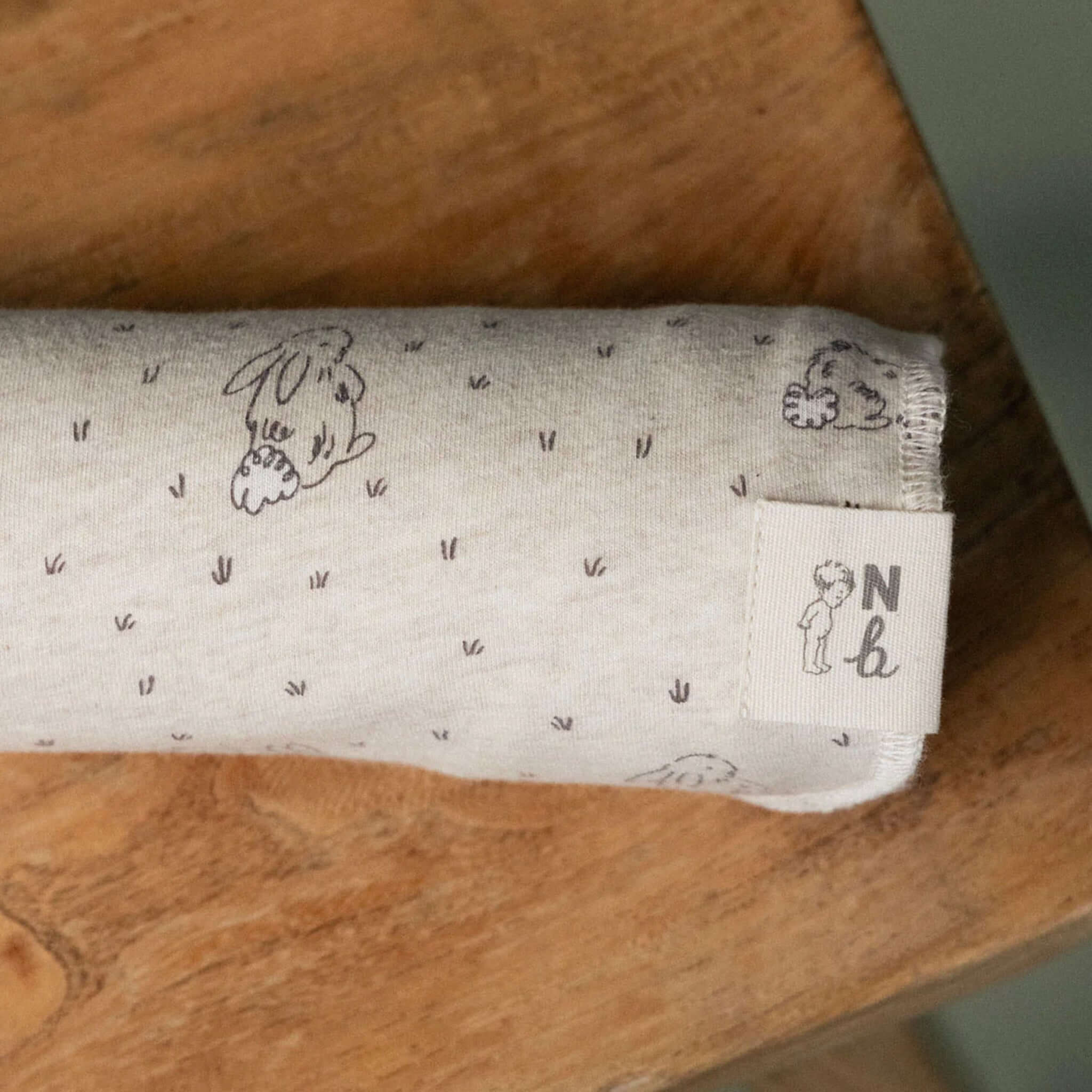 Alt Tag: Nature Baby Organic Cotton Jersey Wrap - Bramble Burrow organic cotton baby swaddle wrap with bunny print, soft stretchy newborn blanket