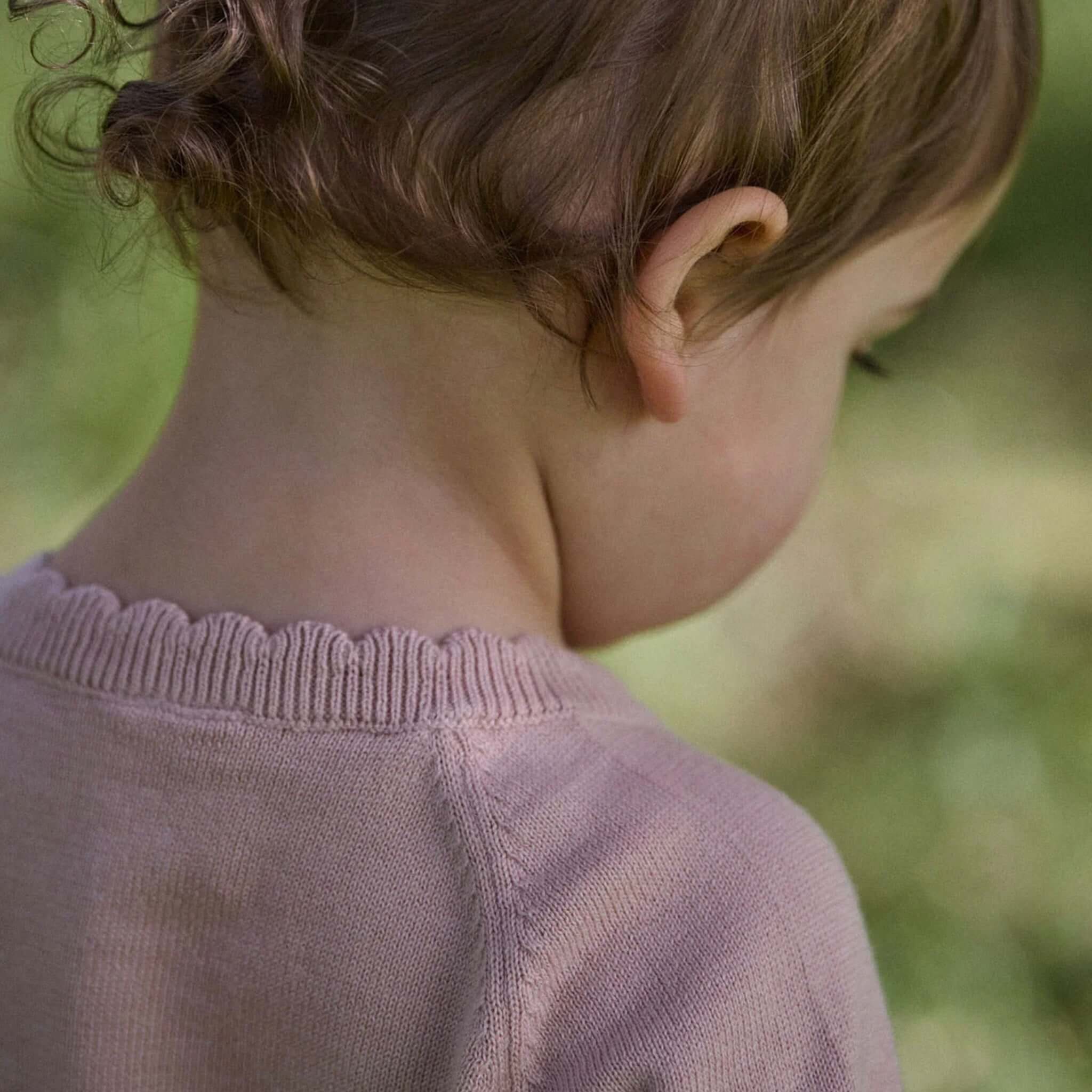 Nature Baby Organic Cotton Liliette Cardigan - Rose Dust shown from behind, featuring scalloped trim detail.
