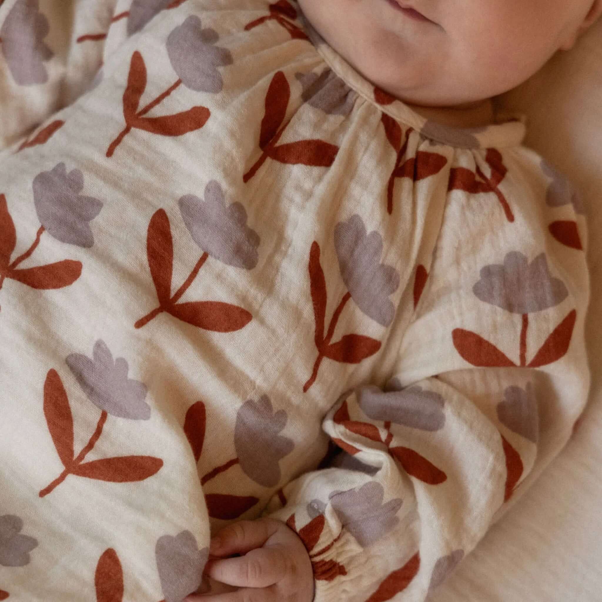 Nature Baby Organic Cotton Meadow Long Sleeve Muslin Bodysuit - Fleurette with floral print in terracotta and mauve.