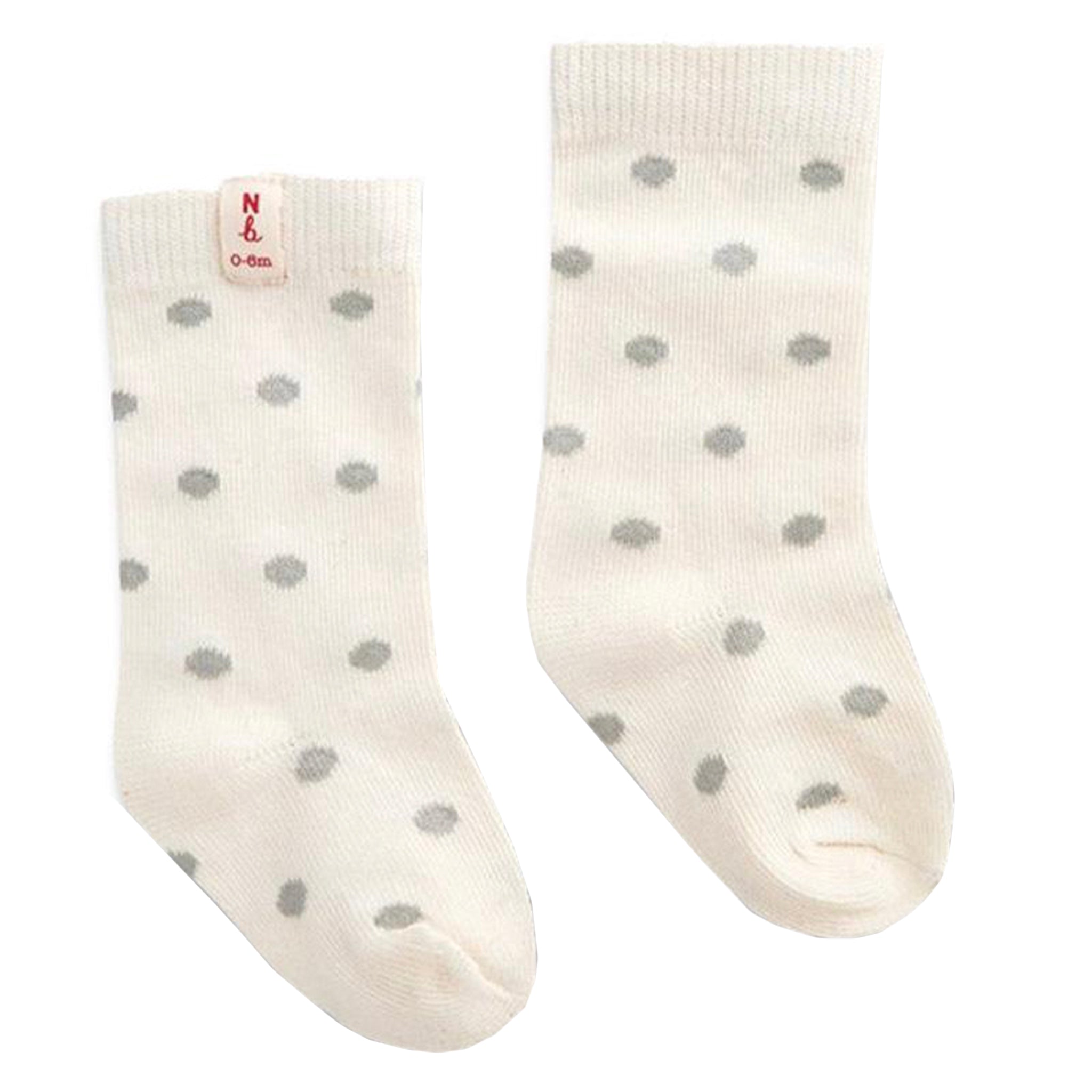 Pair of cream socks with gray polka dots on a white background