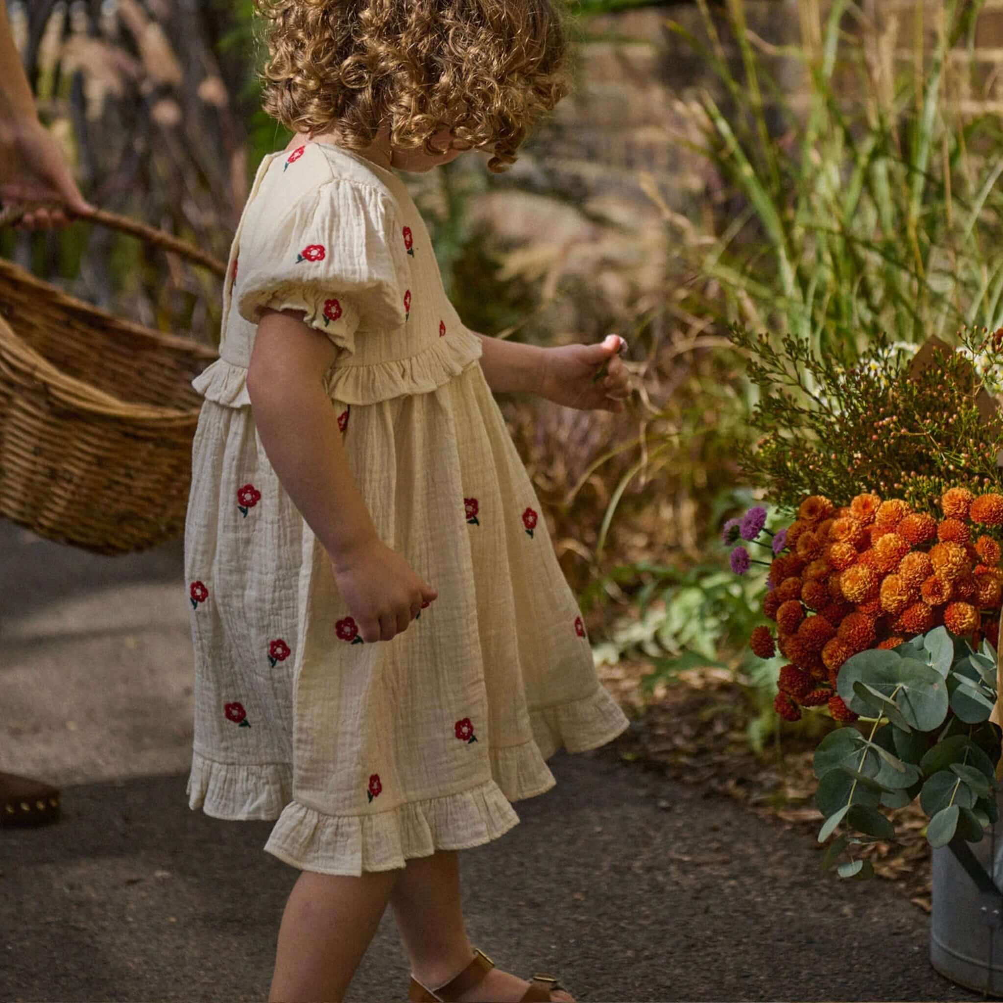 Nature Baby Organic Cotton Valentina Dress - Red Flora being worn by a child, featuring red floral embroidery.