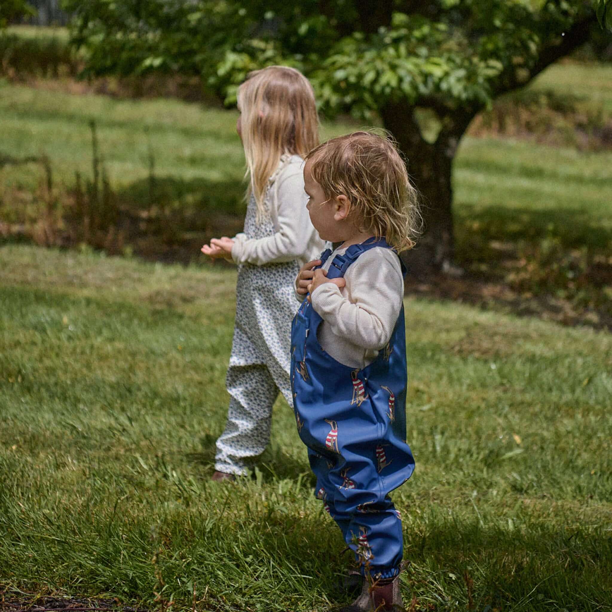 Alt Tag: Nature Baby Splash Overalls - Briarwood Heron toddlers playing outdoors in waterproof splash overalls for wet weather adventures