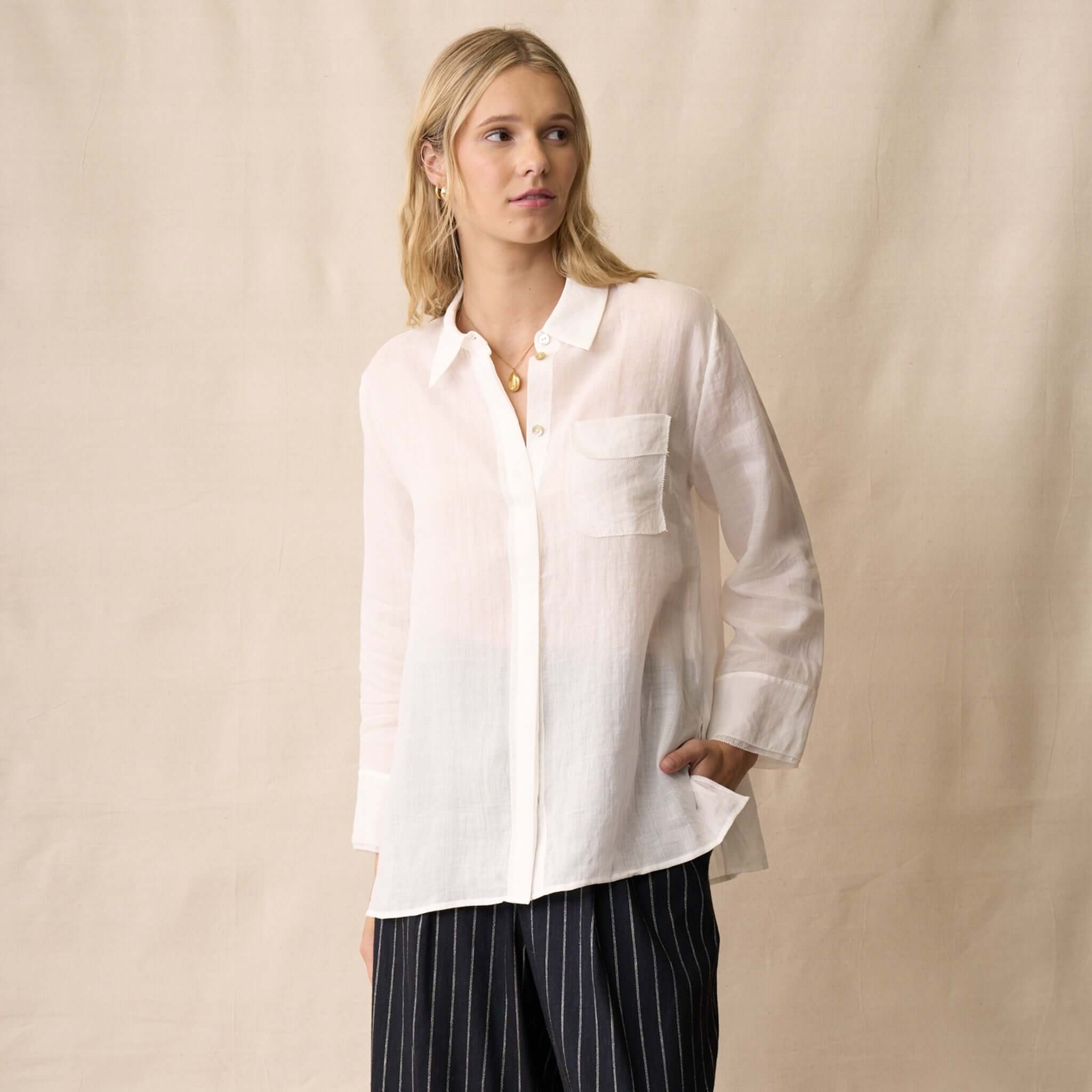 Neris Drew Shirt - White worn by a model, showcasing its sheer fabric and classic collar.