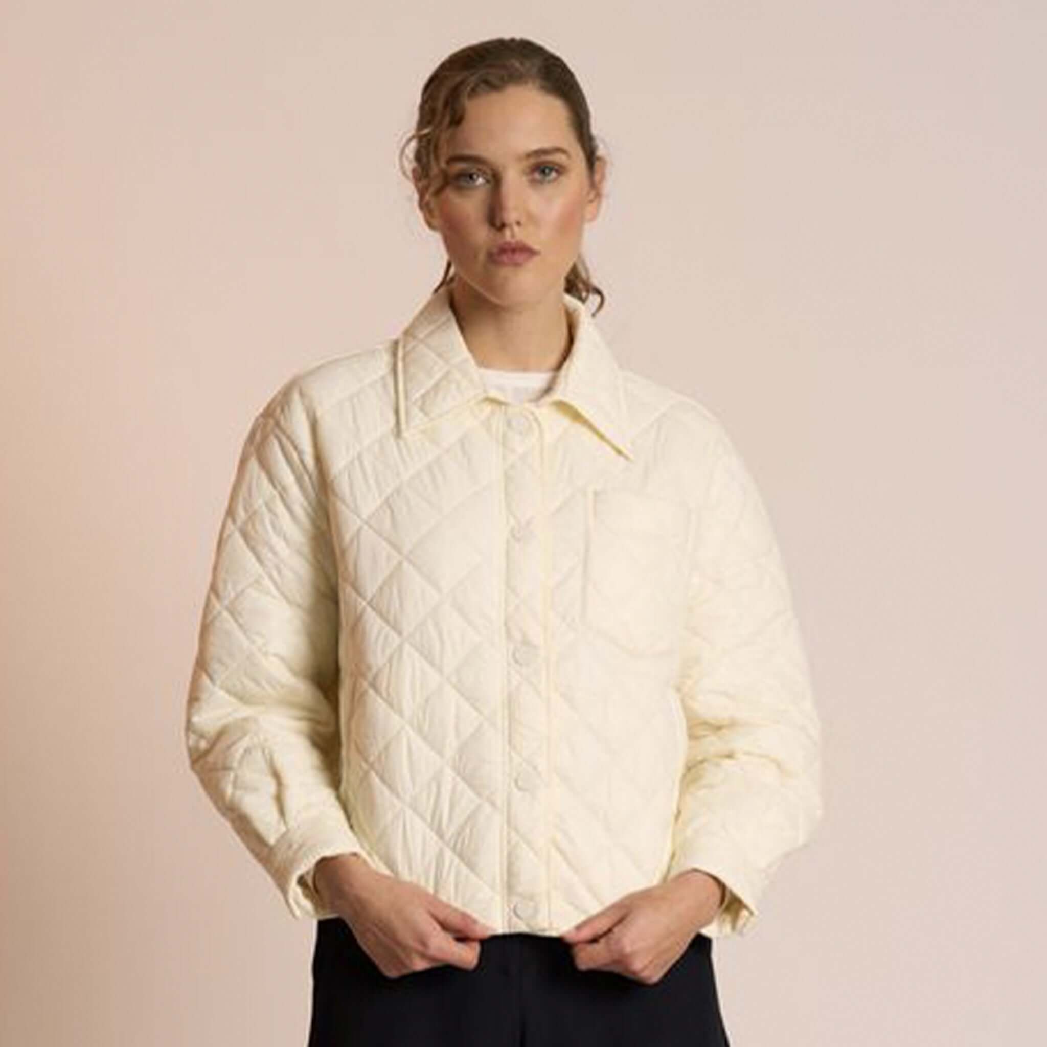 Alt Tag: Neris Gia Jacket - Egret quilted cropped jacket in soft cream with snap domes, structured collar and drawstring hem