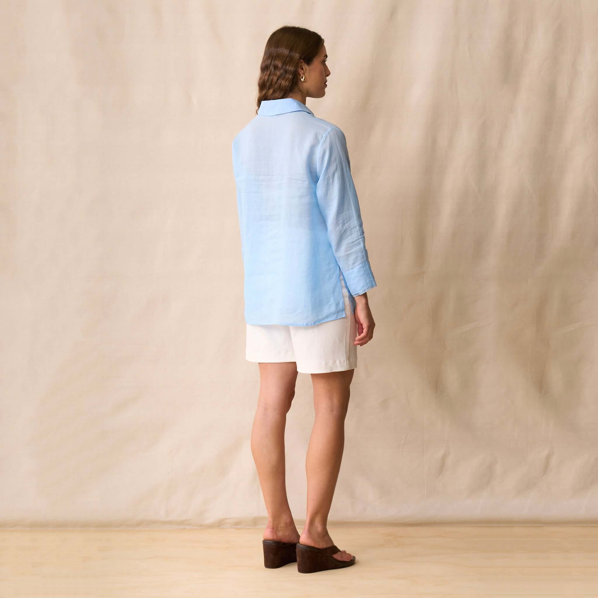 Back view of a model wearing the Neris Drew Shirt - Skye in soft sky blue against a neutral background.
