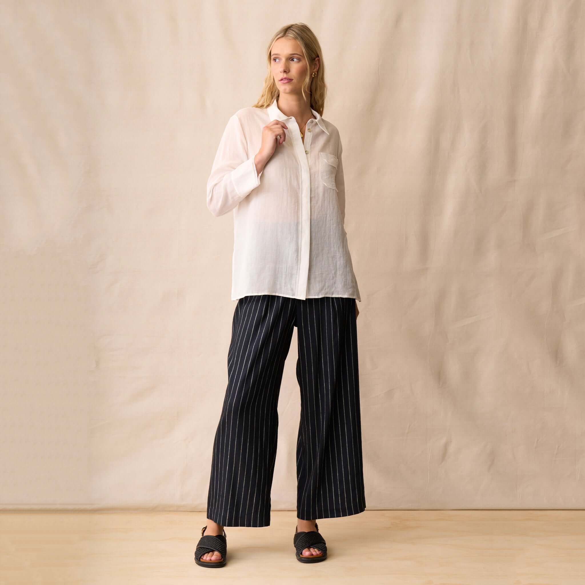 Neris Drew Shirt - White worn with striped pants, featuring a classic collar and button-front placket.