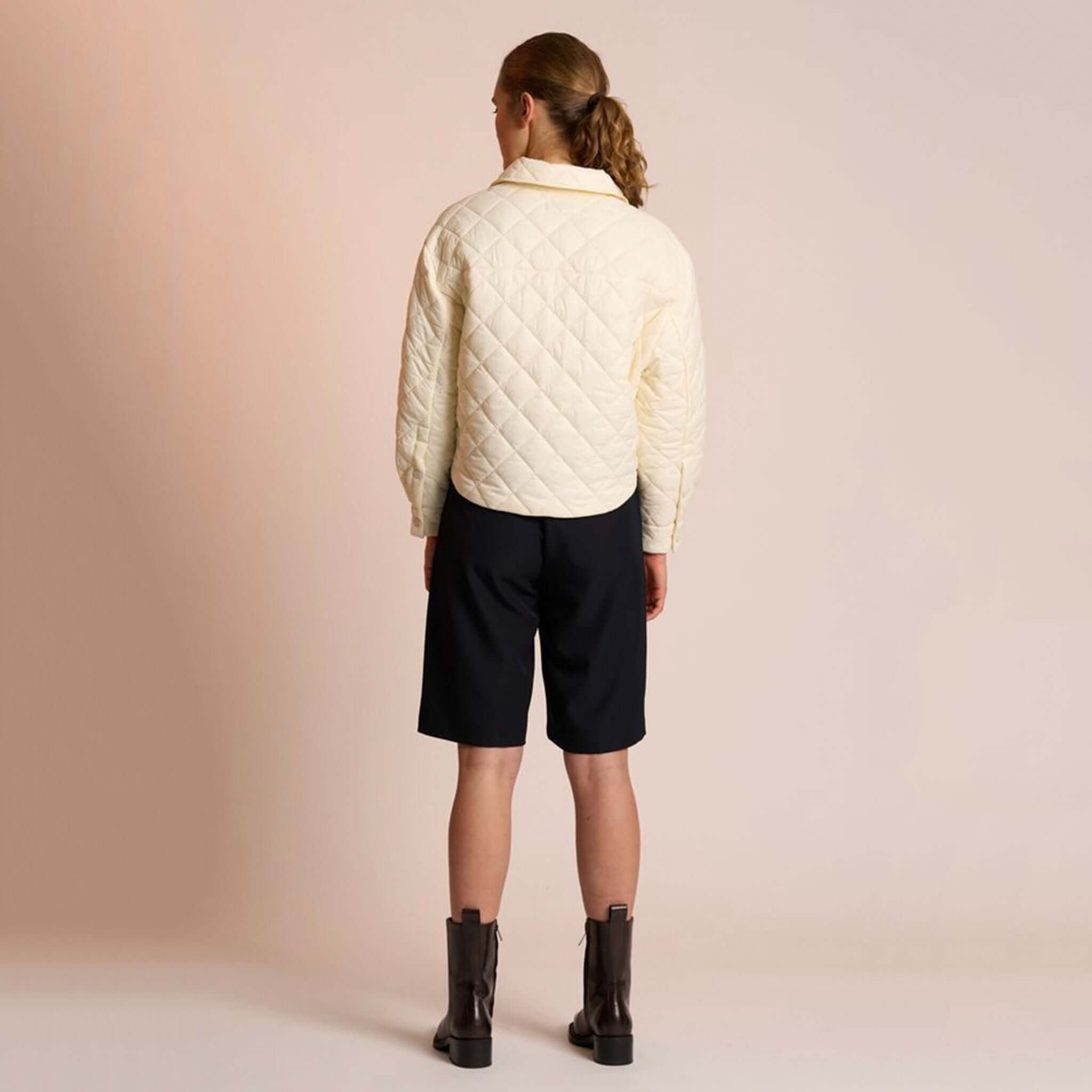 Alt Tag: Neris Gia Jacket - Egret quilted cropped jacket back view in soft cream with collar, cosy minimalist layer