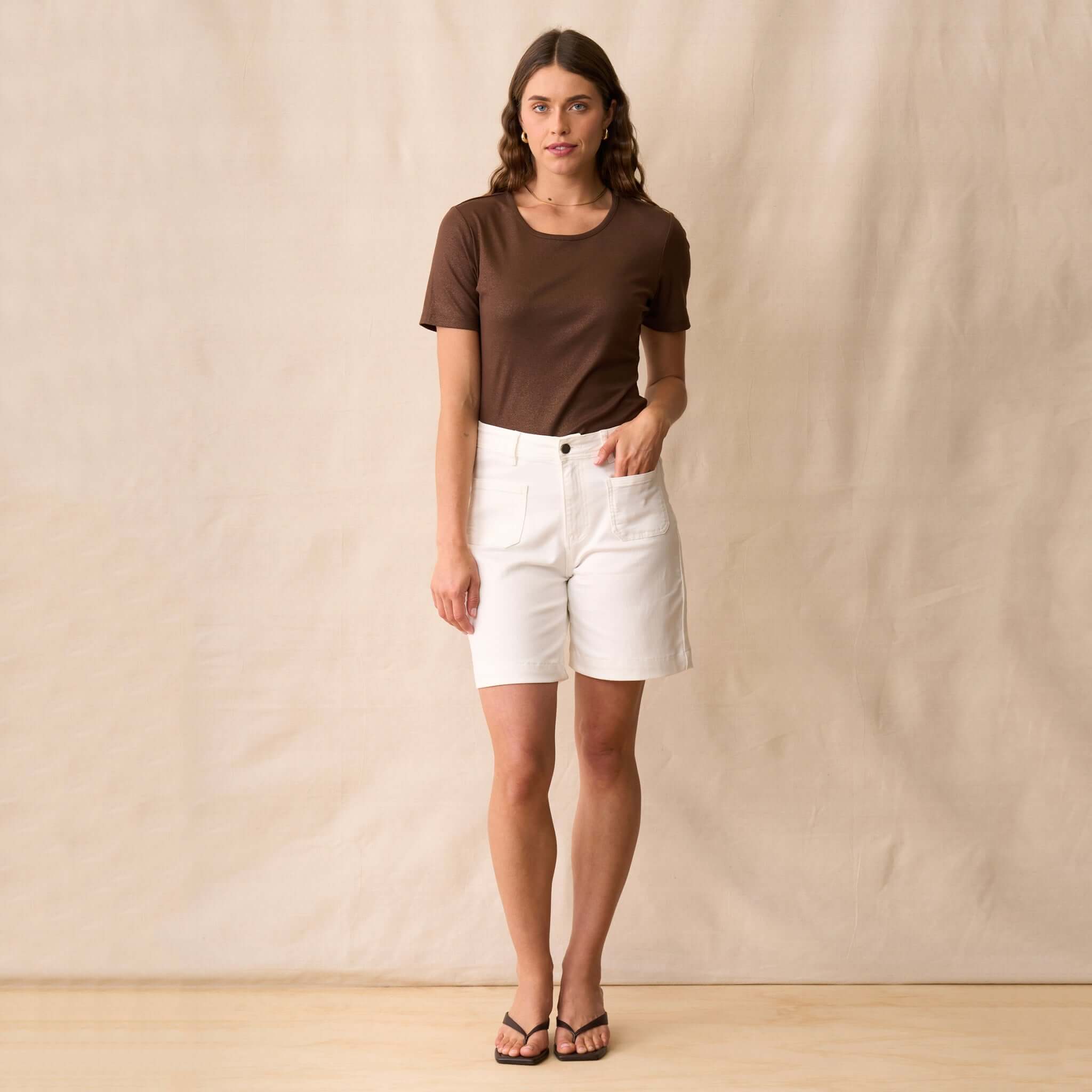 Neris Ziggy Tee - Copper styled with white shorts and sandals on a model against a neutral background.