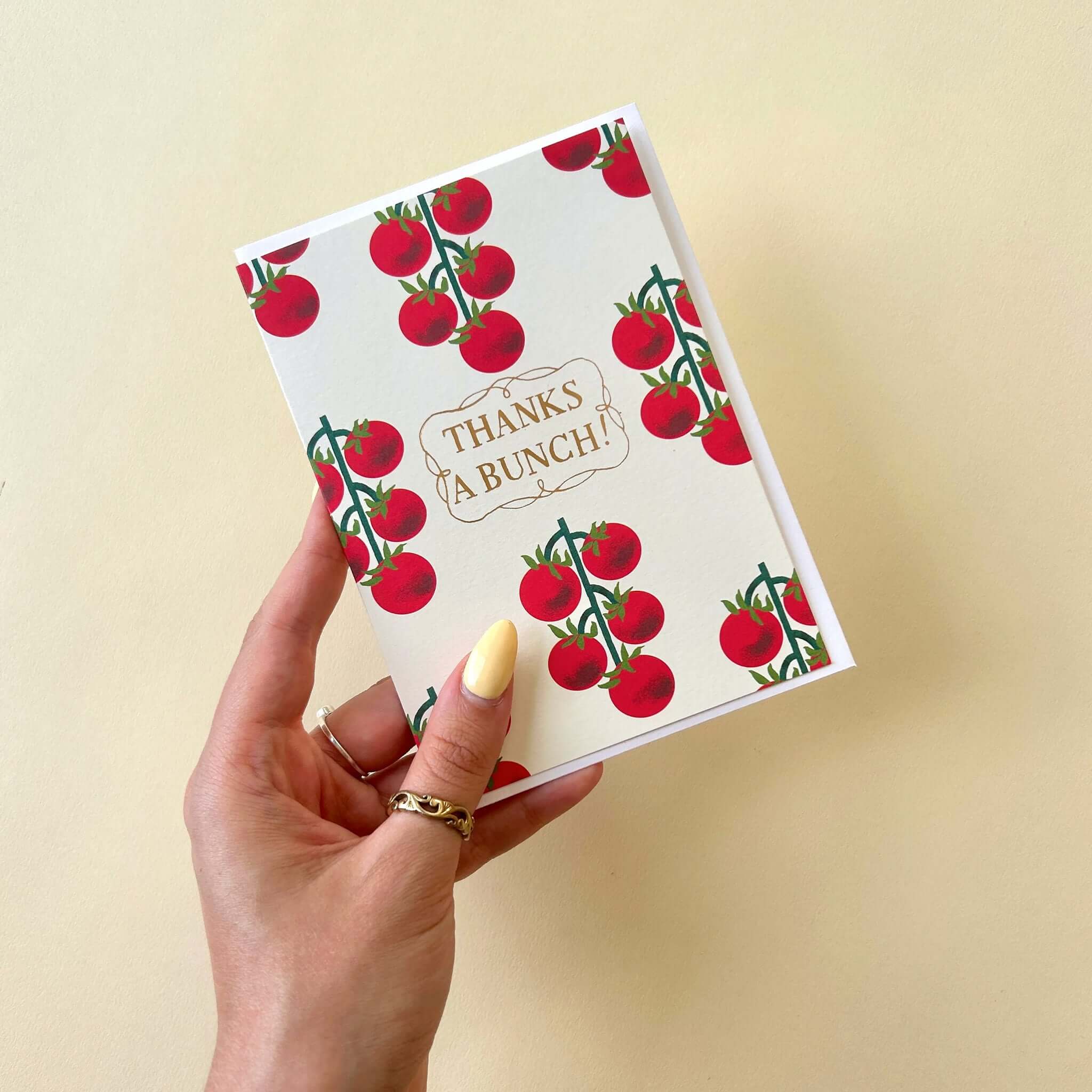 Noi Publishing Card - Tomato Vines Thank You with bold tomatoes and gold foil lettering in hand.