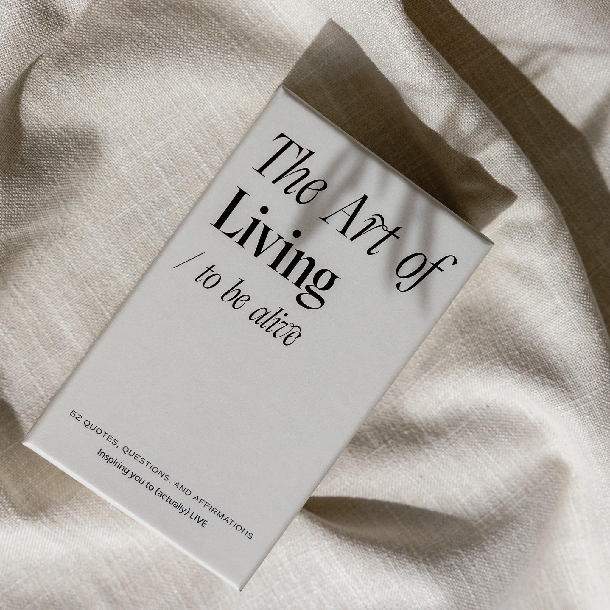Book titled 'The Art of Living to be alive' on a textured beige surface