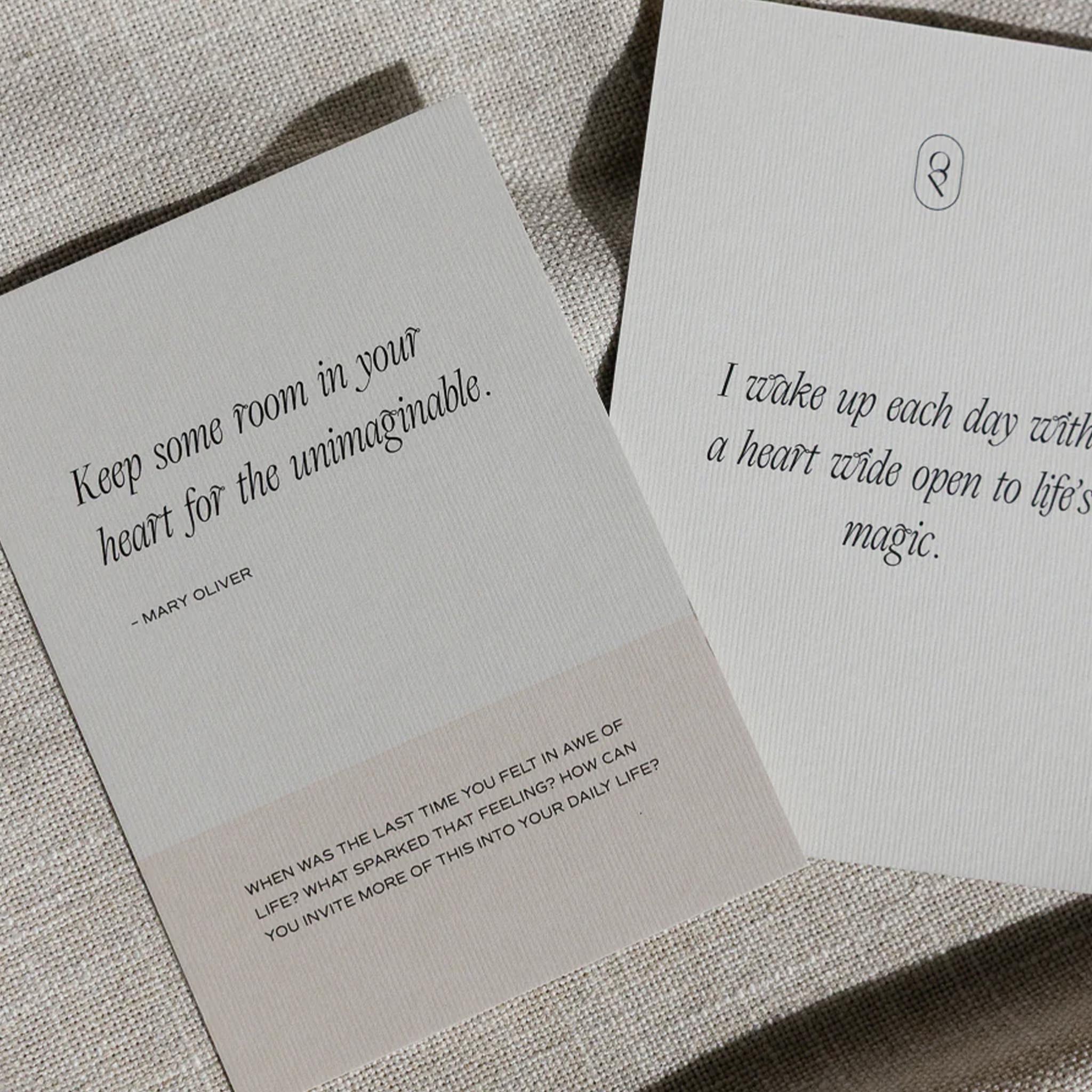 Two cards with inspirational quotes on a textured surface