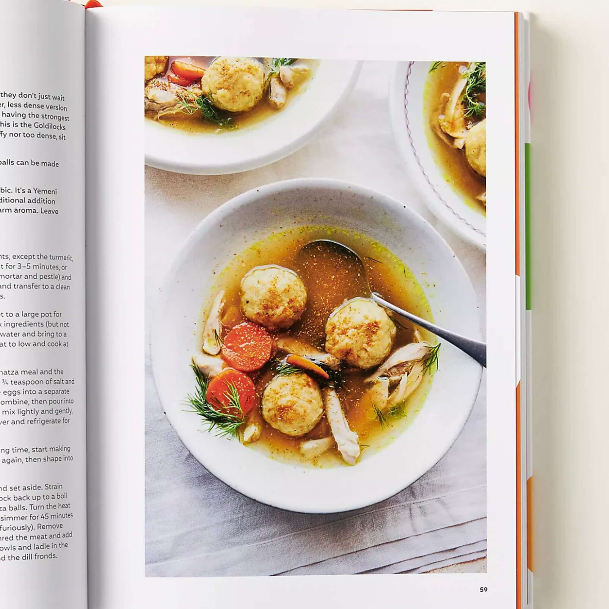 Alt Tag: Ottolenghi Comfort cookbook open to a comforting recipe page with plated soup and dumplings, showcasing home-style cooking