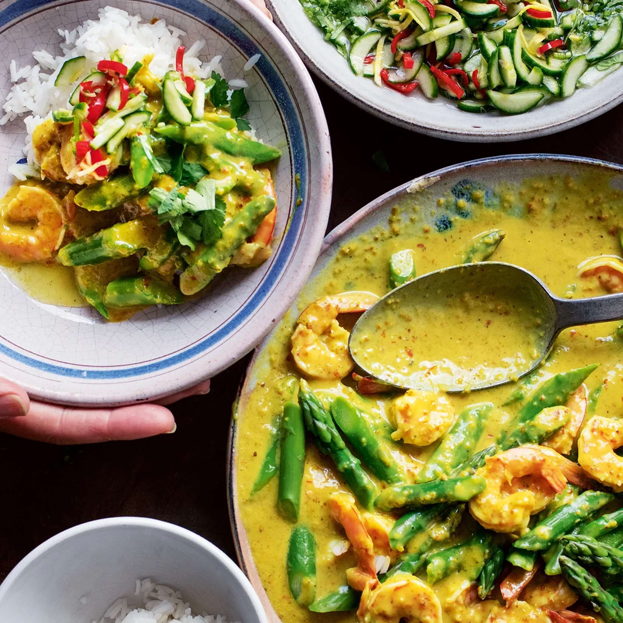 Alt Tag: Ottolenghi Comfort cookbook recipe photo of prawn and asparagus curry with rice and cucumber salad, vibrant comforting home cooking