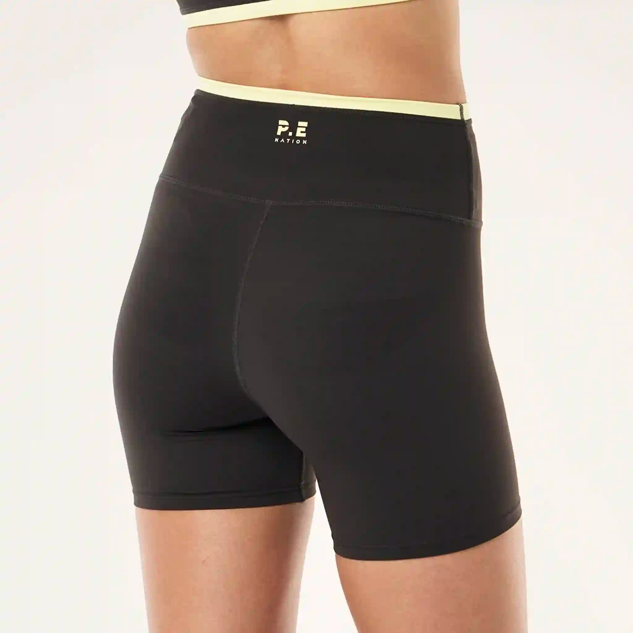 Black athletic shorts with a logo on a plain background