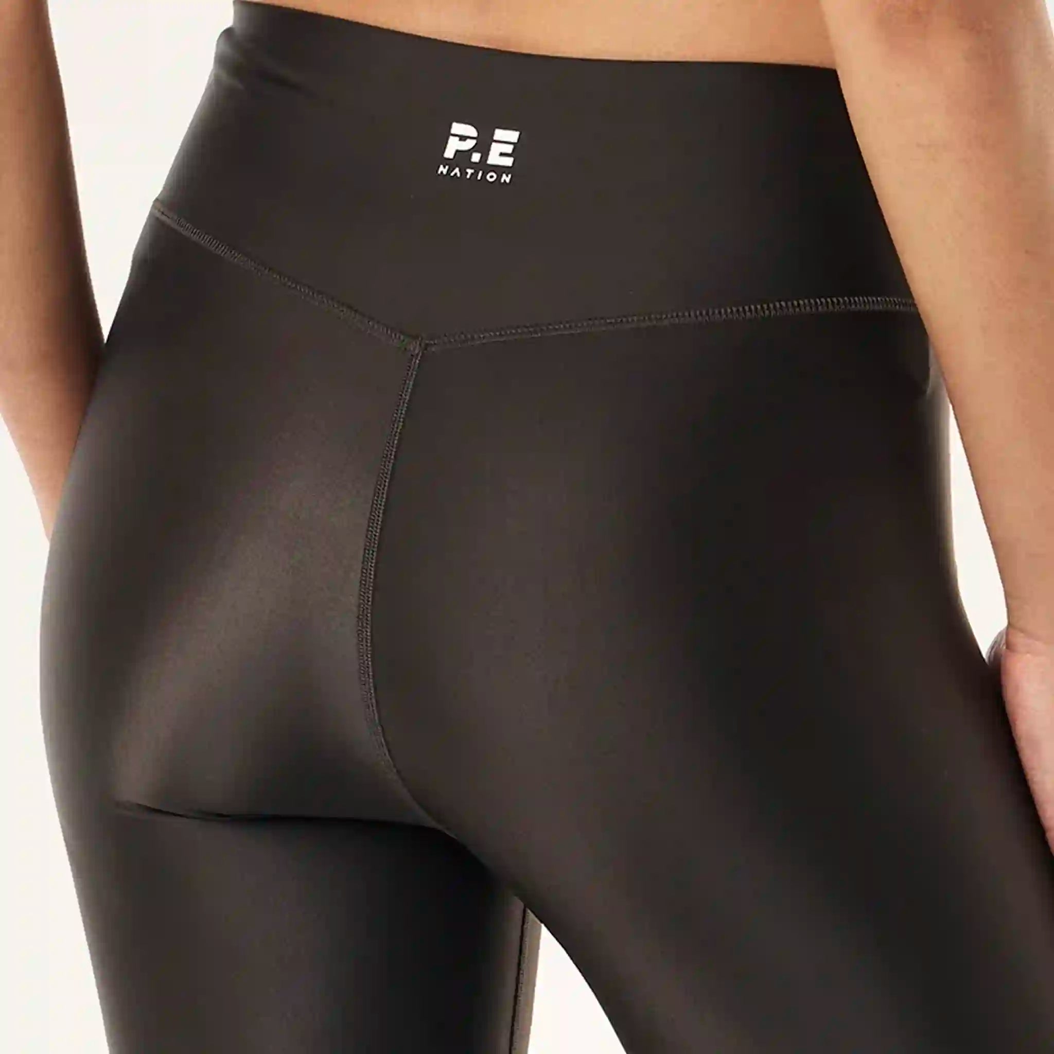 Black leggings with a visible brand logo on a neutral background