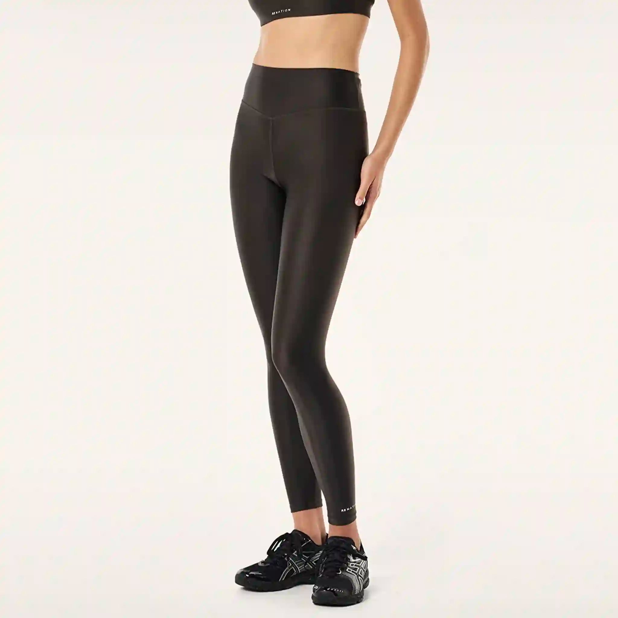 Person wearing black leggings on a white background