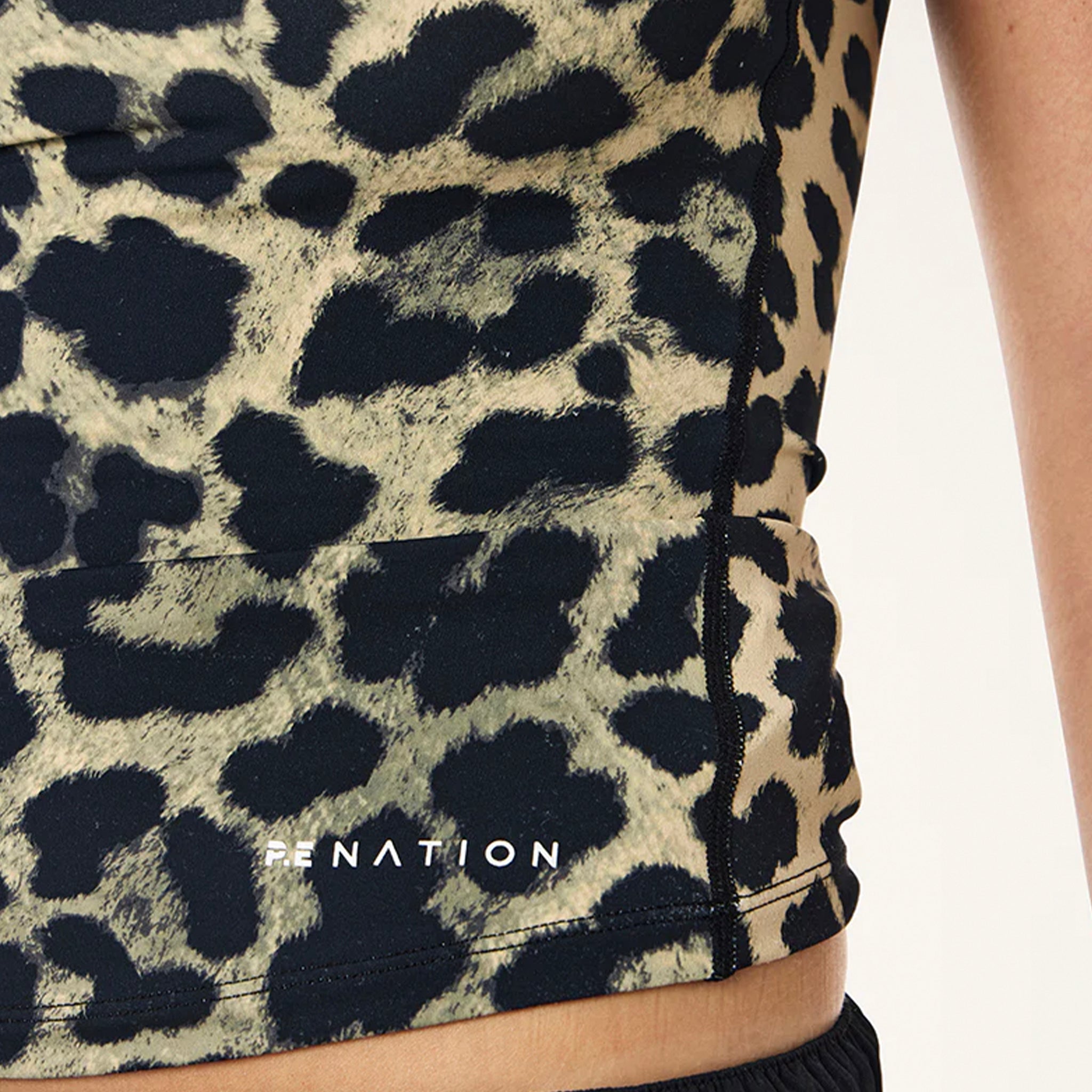 Leopard print sleeveless top with 'RE NATION' logo on a white background