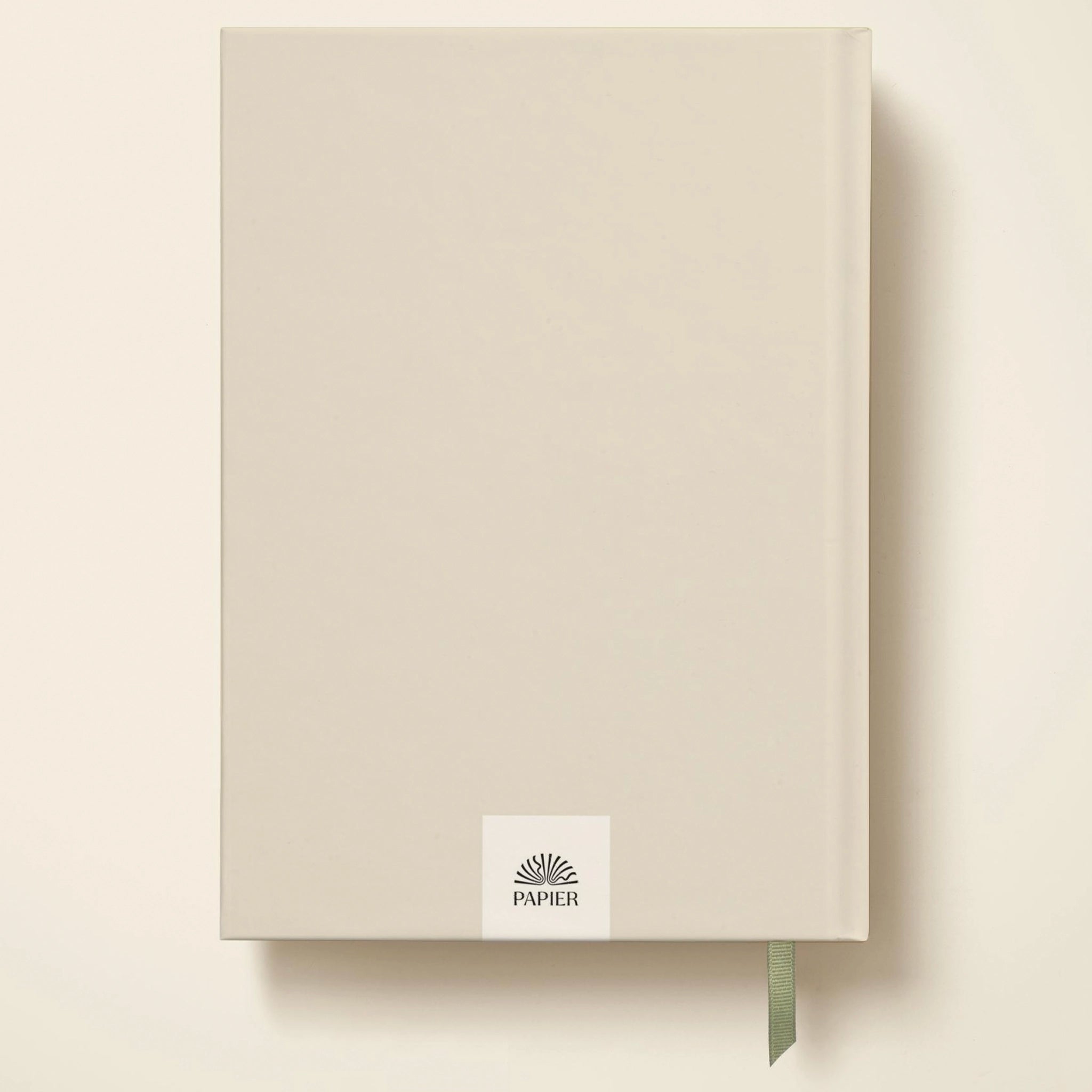 Beige notebook with 'PAPIER' logo on a light beige background