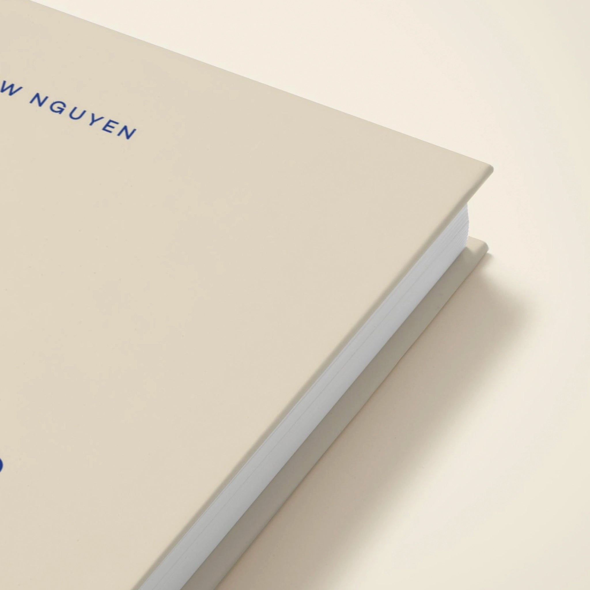 Beige notebook with 'W NGUYEN' embossed on the cover