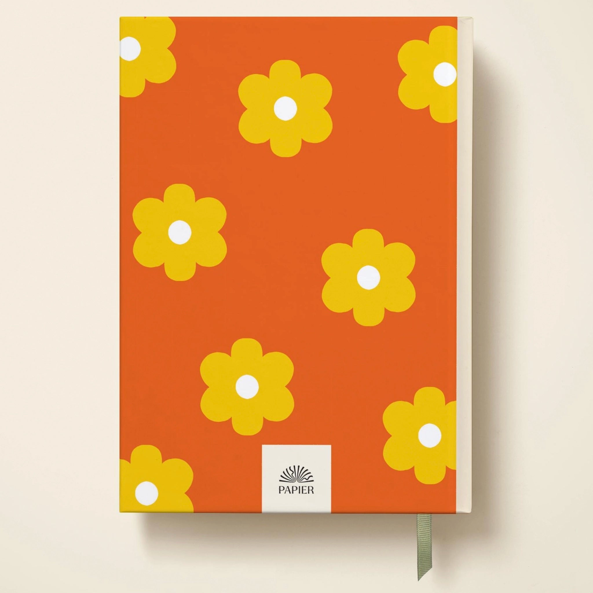 Notebook with yellow flower pattern on an orange background, featuring the brand 'PAPIER'.