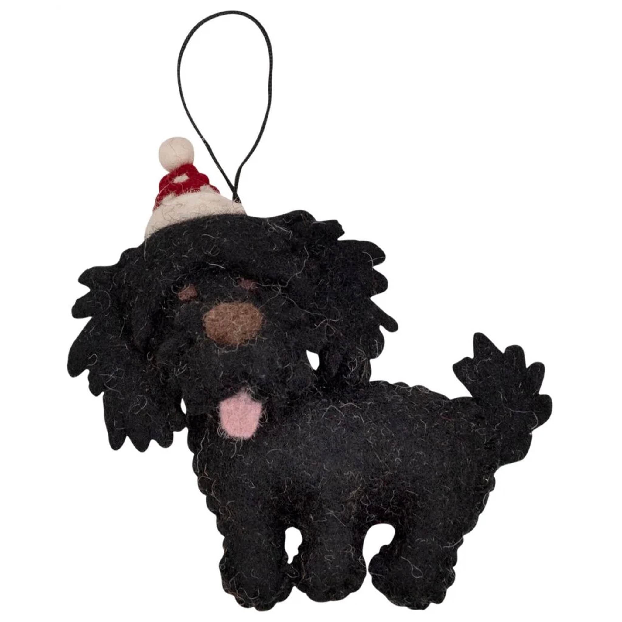 Black dog ornament with a Santa hat on a white background