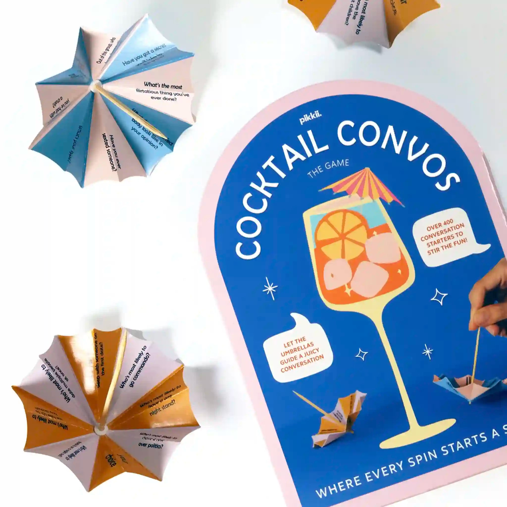 Cocktail Convos game packaging with cocktail-themed design and spinning cards.