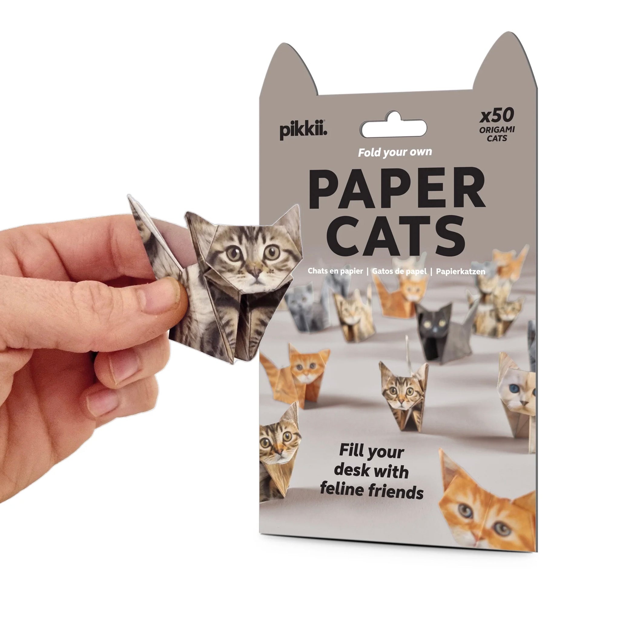Packaging of paper cats with a hand holding one of the cats.
