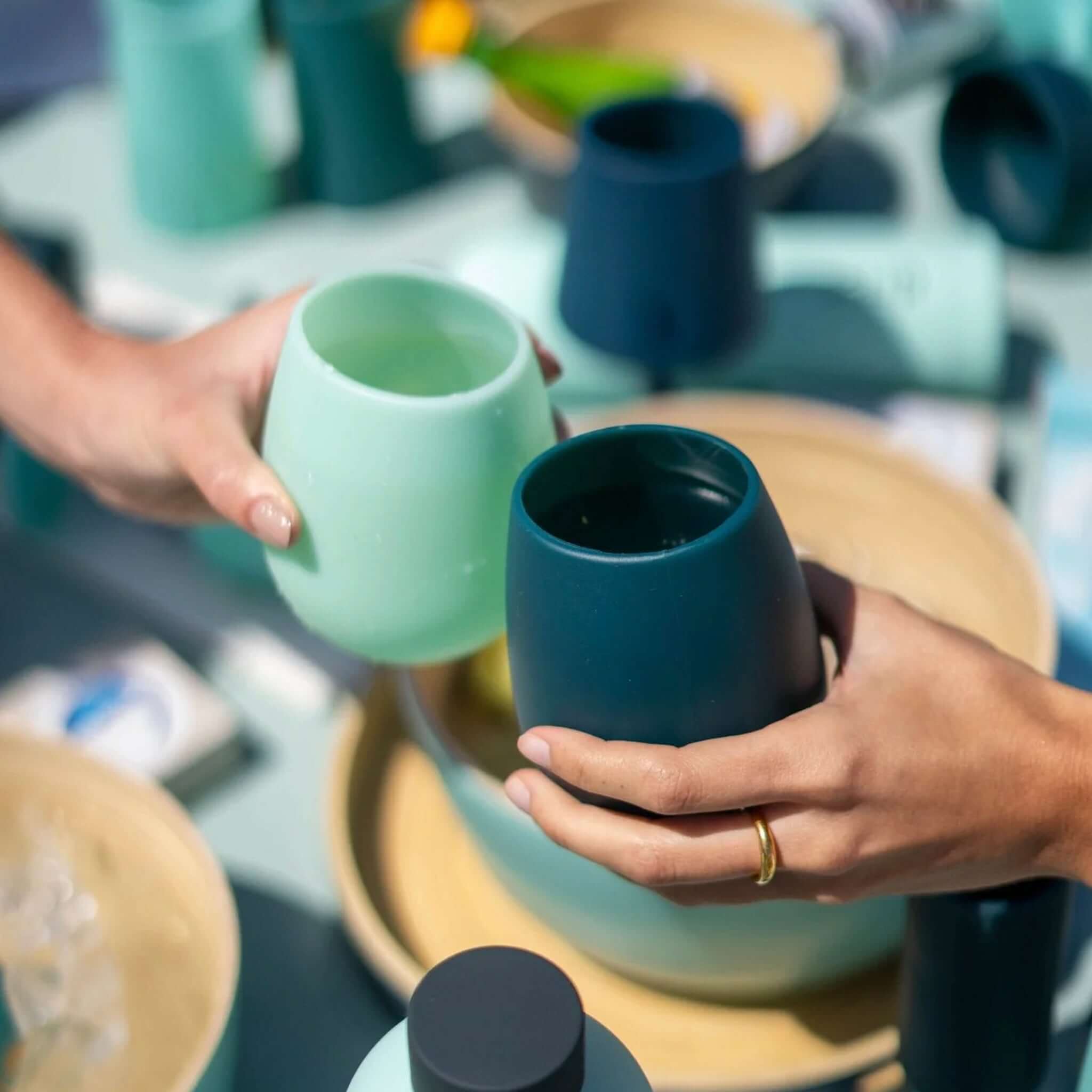 Porter Green Stemm Unbreakable Wine Glass Set - Mist & Ink being shared outdoors.