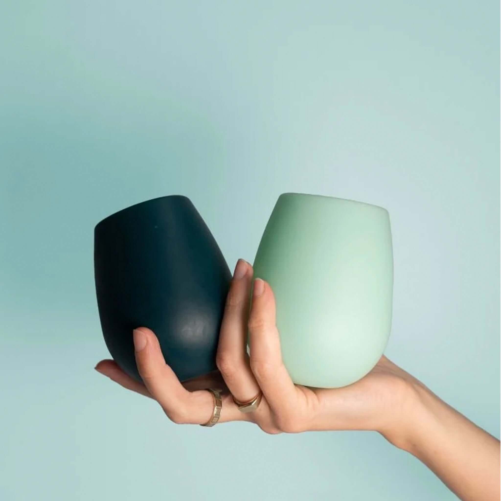 Porter Green Stemm Unbreakable Wine Glass Set - Mist & Ink in hand, showcasing dark and light colors.