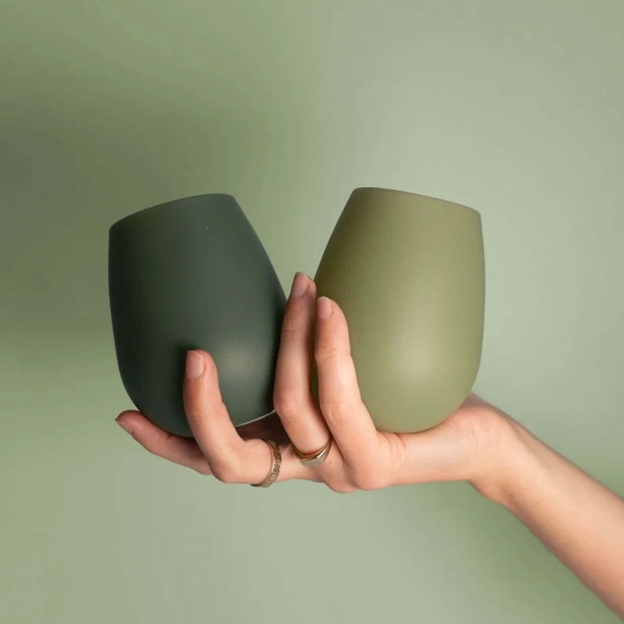 Porter Green Fegg Unbreakable Glass Set - Sage & Olive in hand, showcasing unbreakable silicone tumblers.