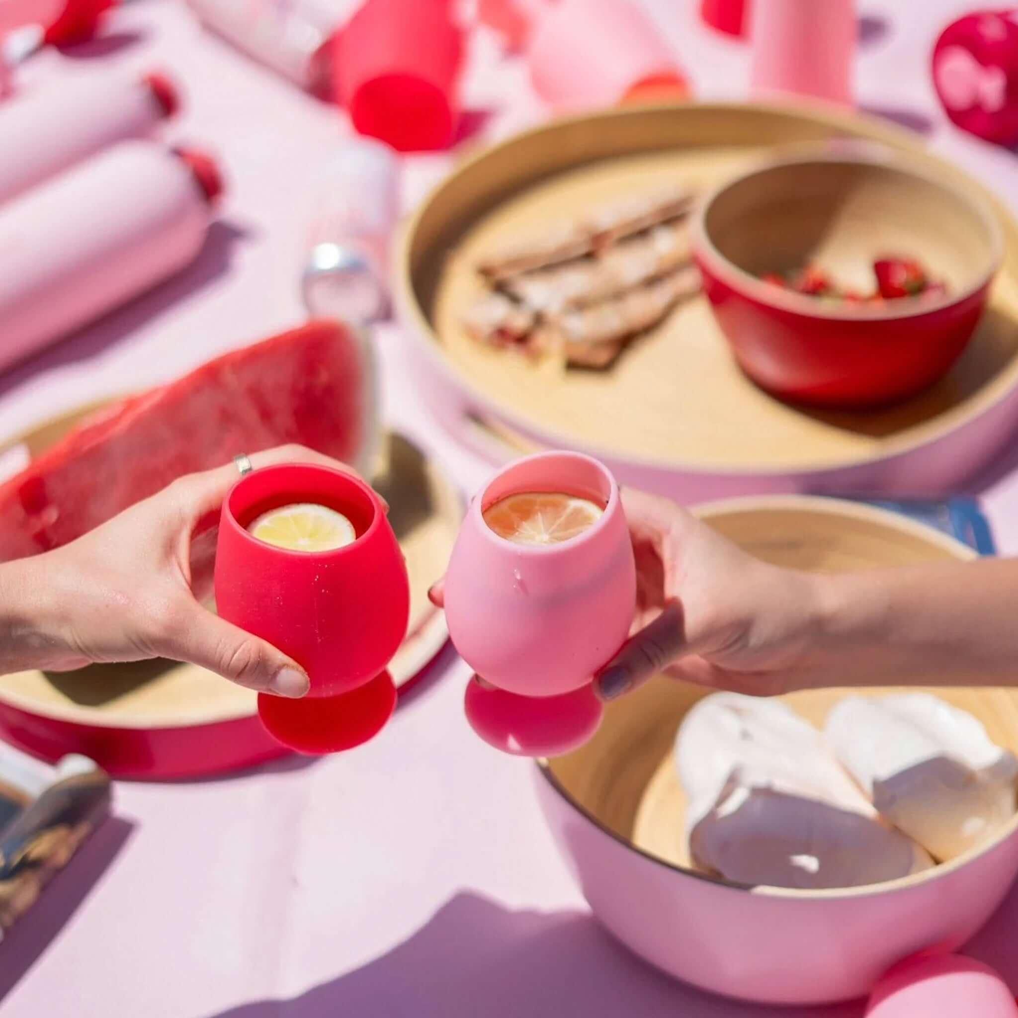 Porter Green Stemm Unbreakable Wine Glass Set - Cherry & Blush being enjoyed outdoors with fresh drinks and snacks.