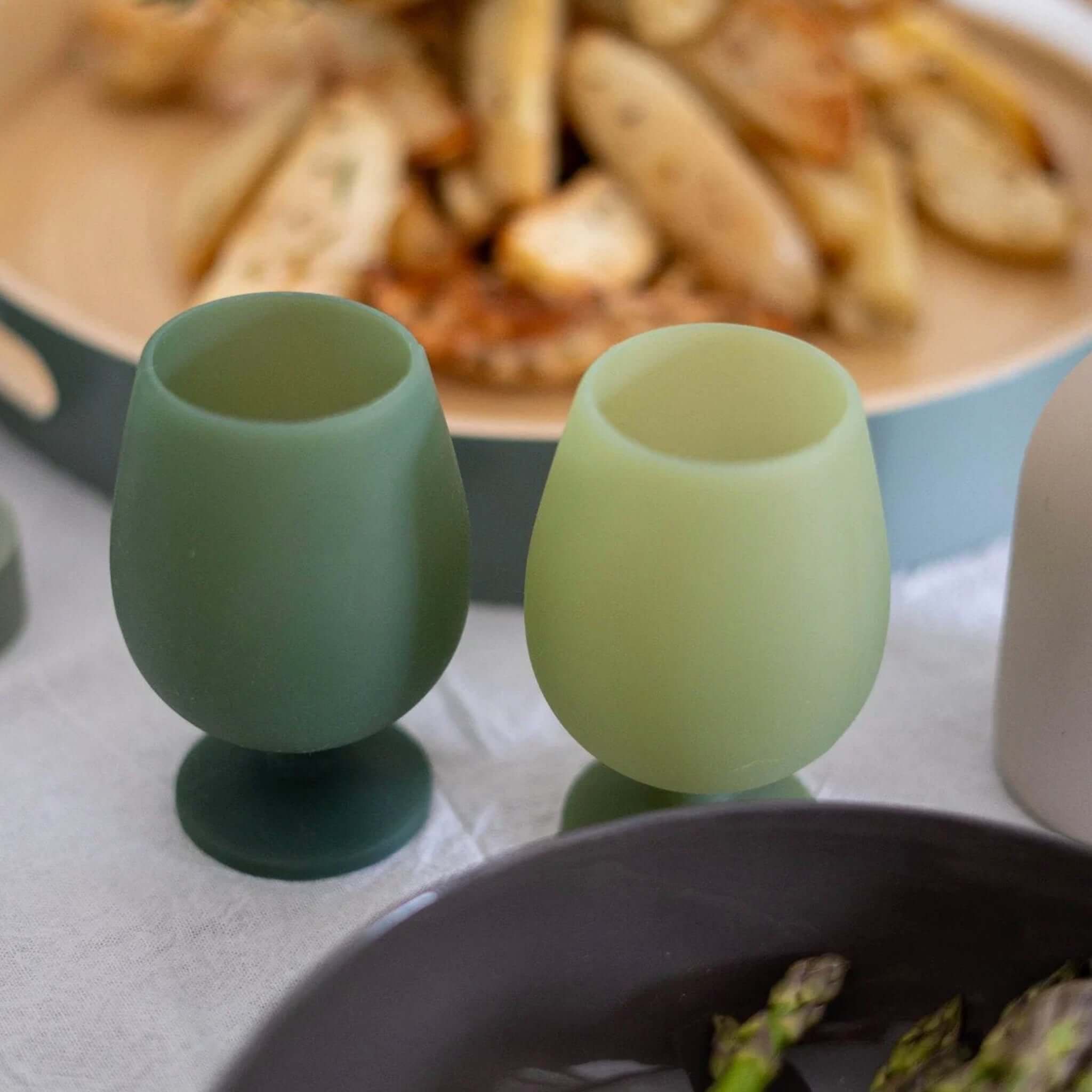 Porter Green Stemm Unbreakable Wine Glass Set - Sage & Olive displayed with food for dining.