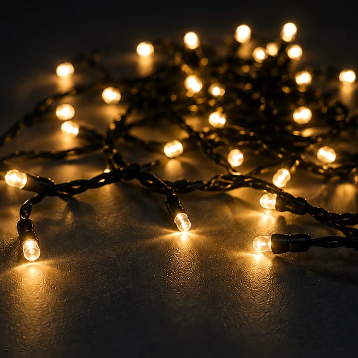 Premium Outdoor Fairy Lights - Mains Powered 20m shown lit along a deck or patio