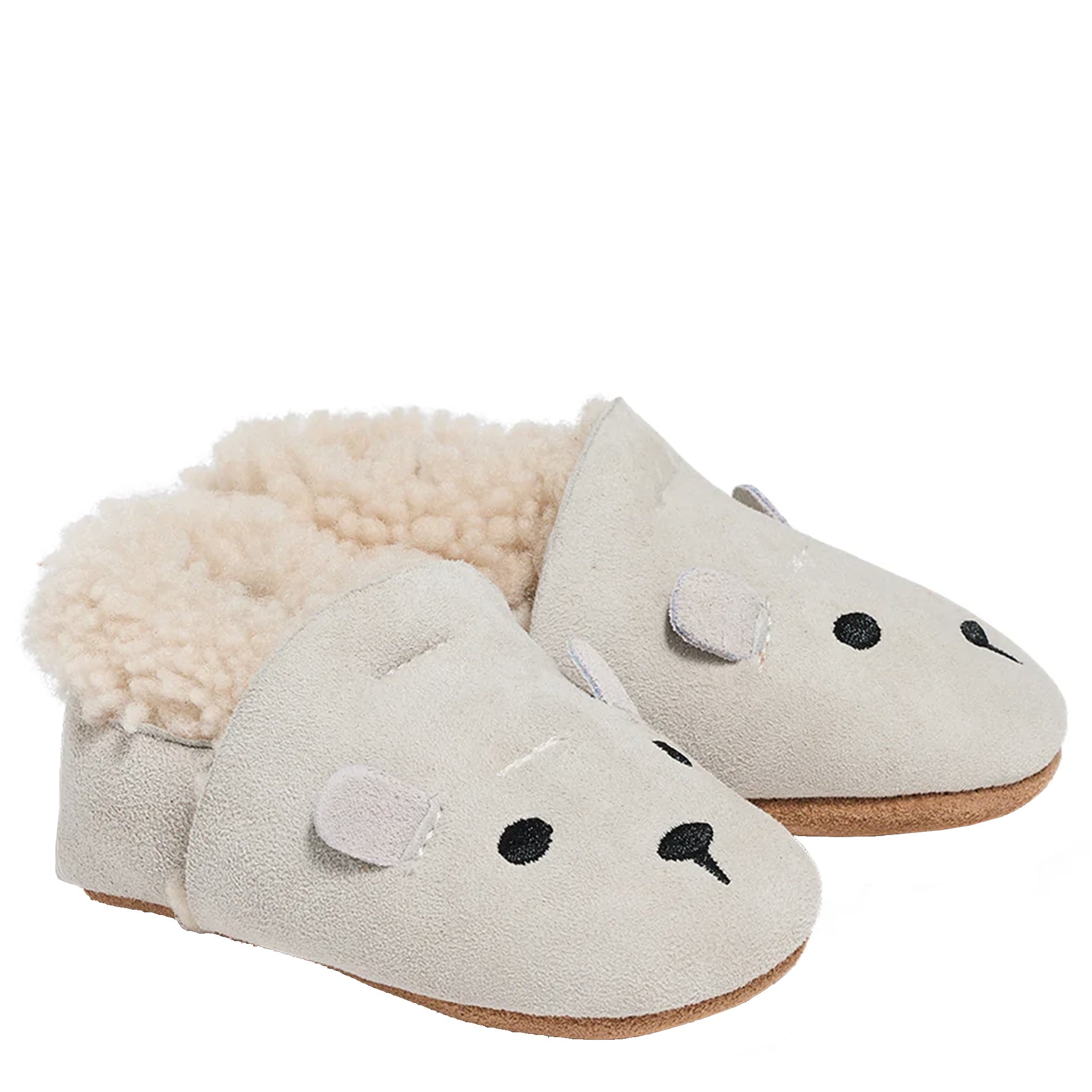 Pair of beige slippers with fluffy interior on a white background