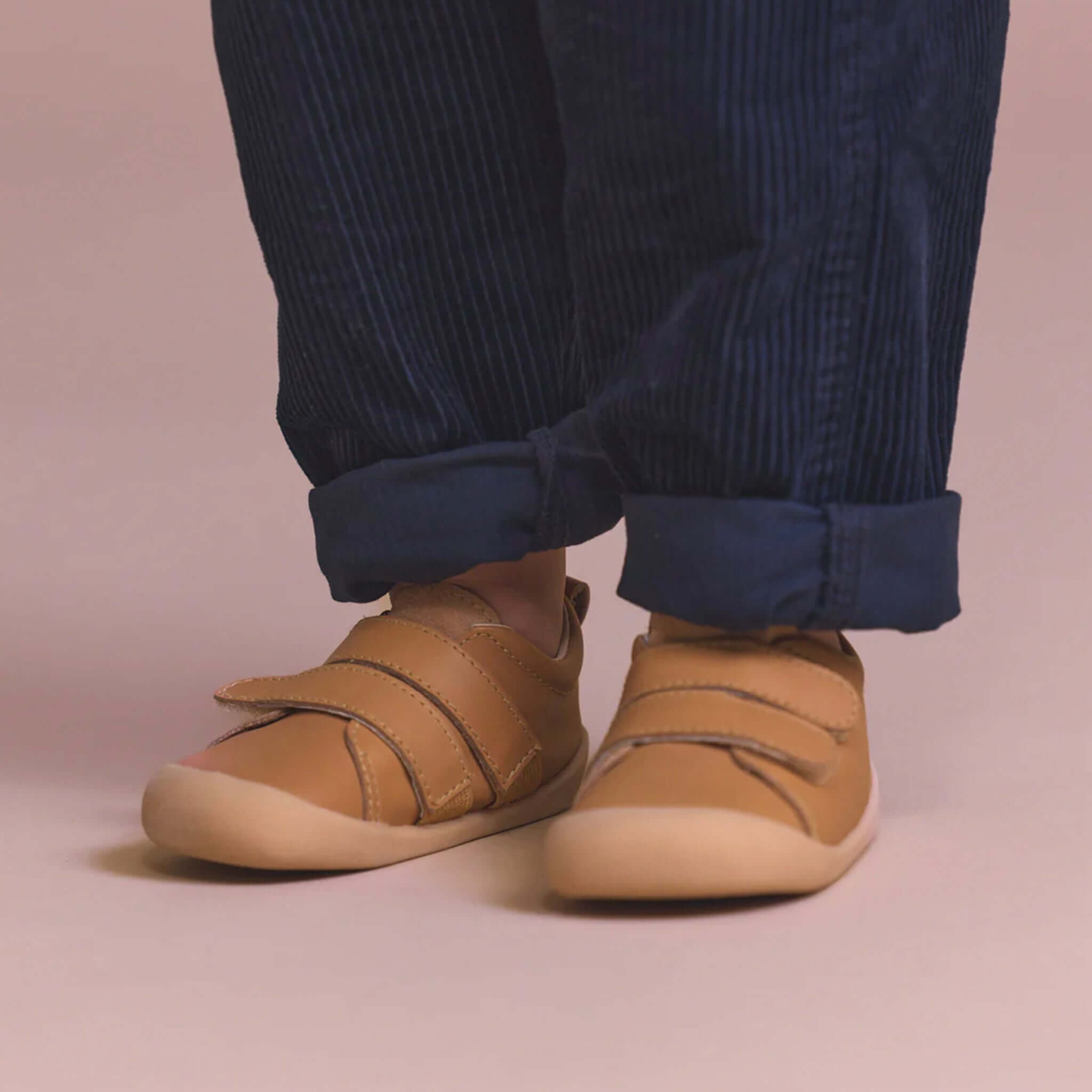Alt Tag: Pretty Brave Toto Baby Sneakers - Tan on baby feet, tan leather first-walker shoes with flexible sole and strap closure