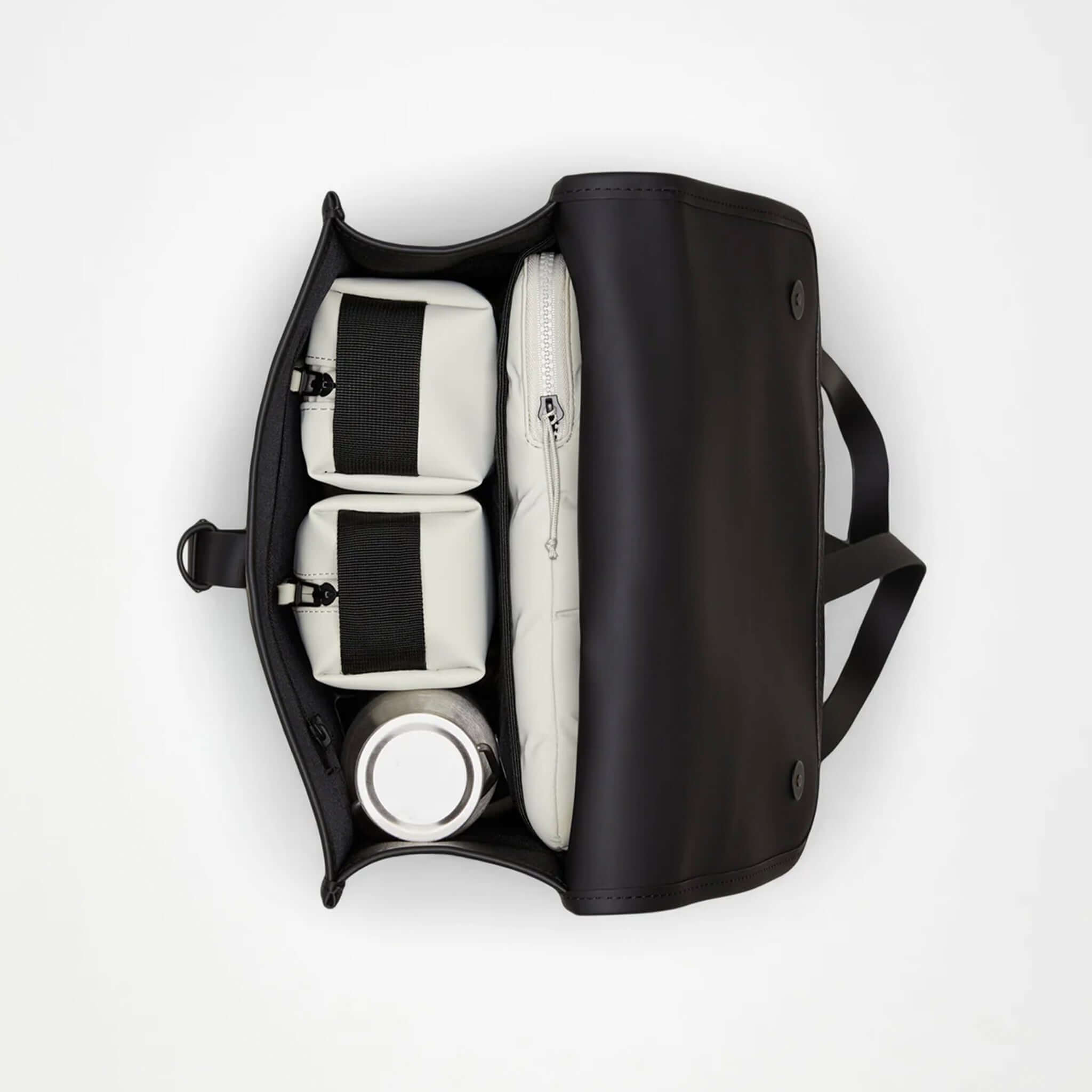 Inside view of the Rains Backpack - Black showcasing organized compartments and a sleek design.
