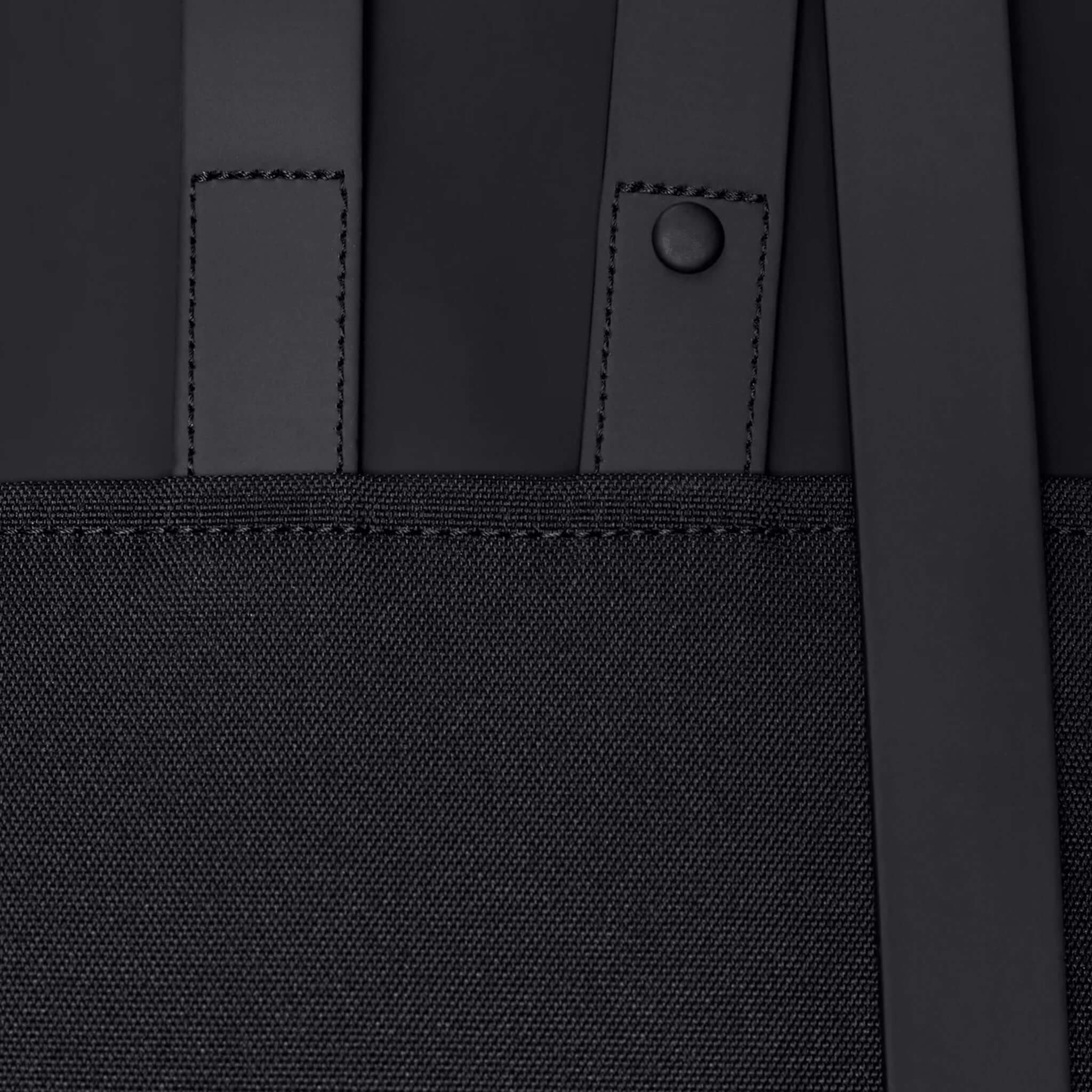 Rains Backpack Mini - Black close-up of straps and fabric details in sleek black finish