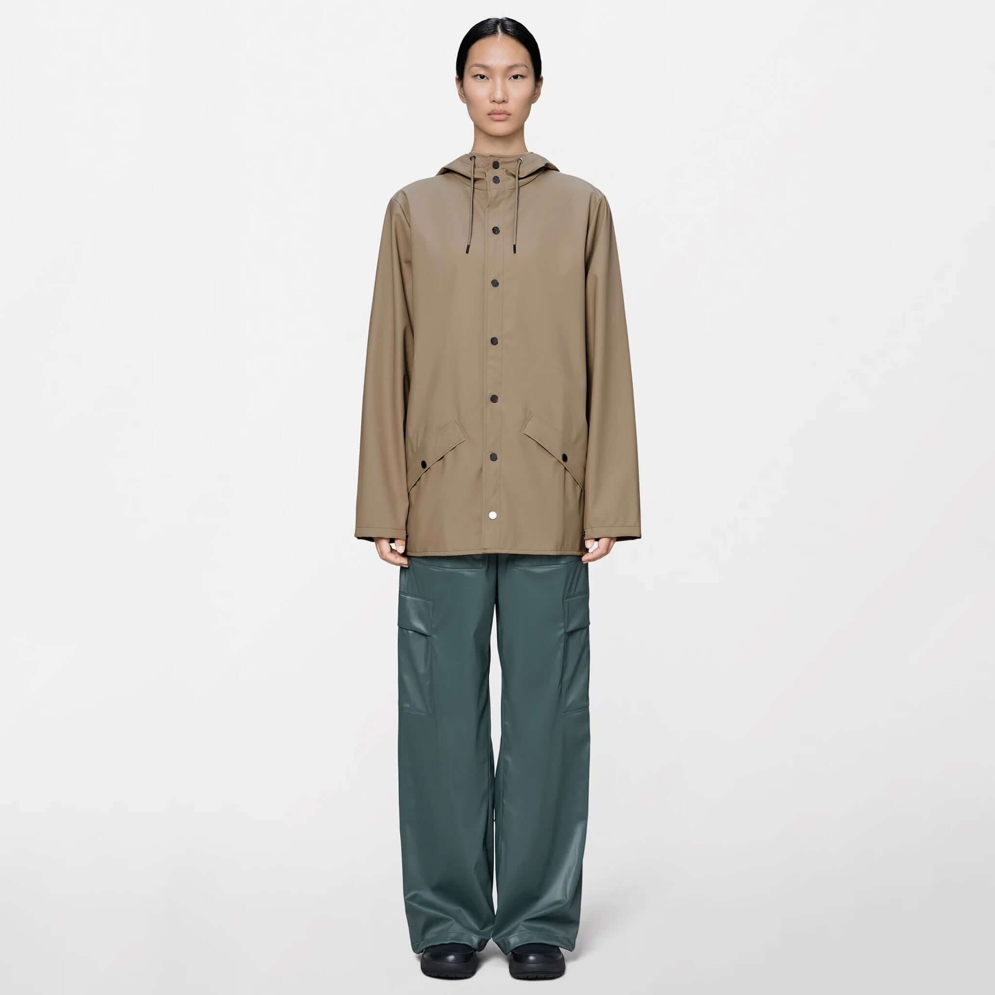 Rains Jacket - Beige worn by model, showcasing its minimalist design and functional style.