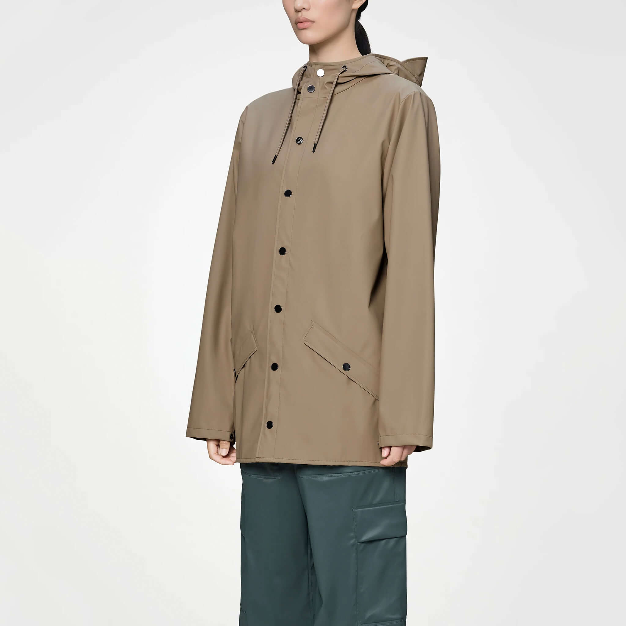 Rains Jacket - Beige worn by a model, showcasing its minimal design and practical features.