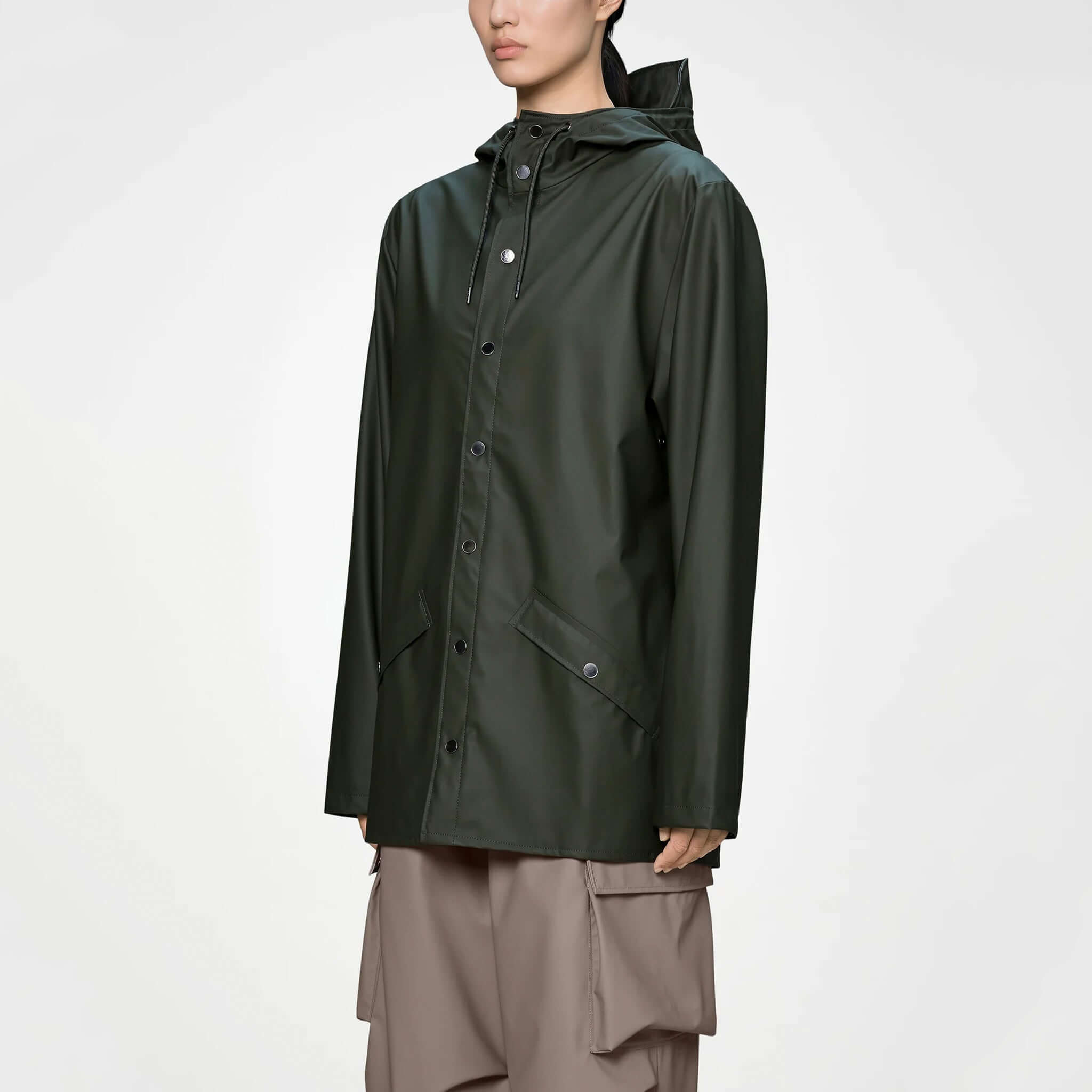 Rains Jacket - Green displayed on a model showcasing its minimal design and functional features.
