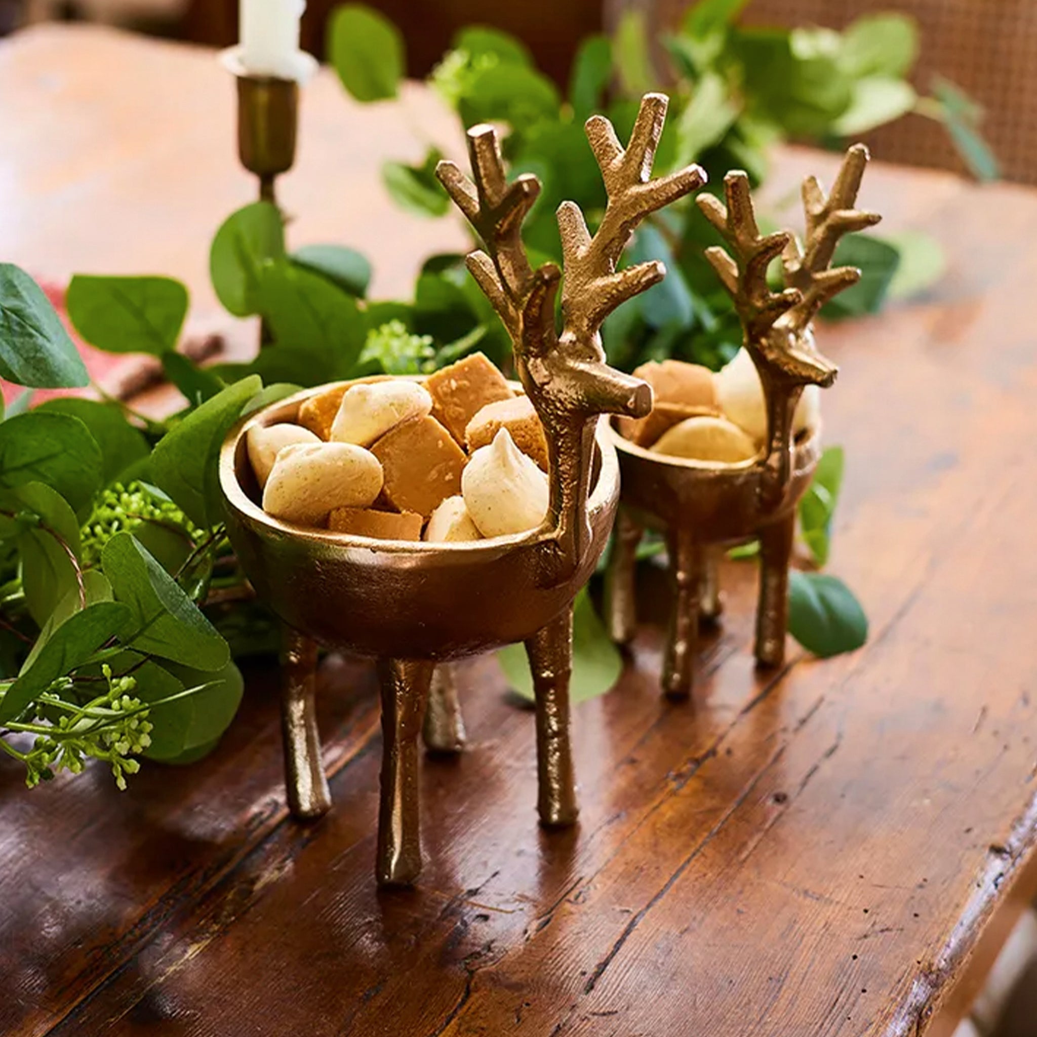 Gold deer-shaped sweets bowls on a wooden table