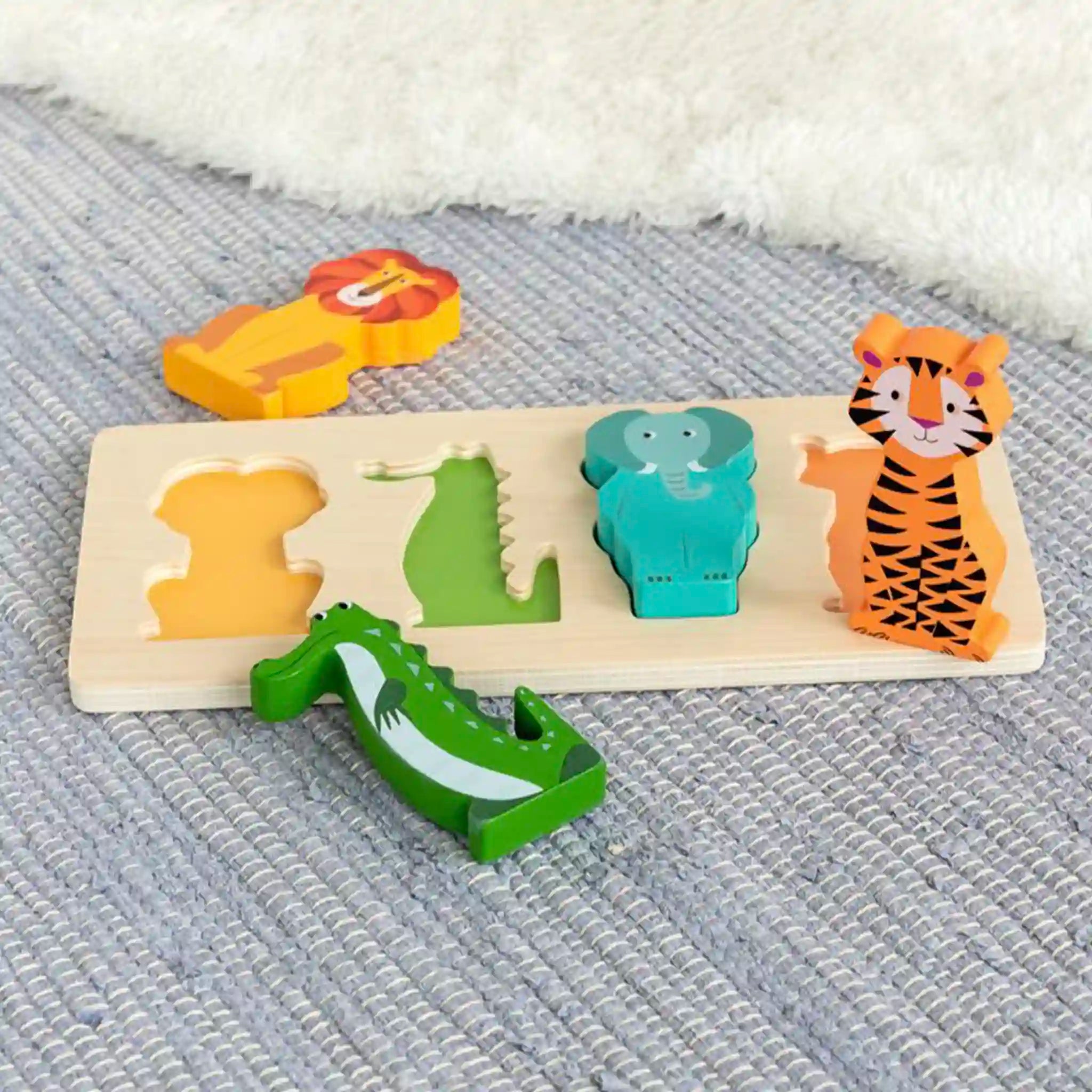 Wooden puzzle with animal shapes on a textured surface
