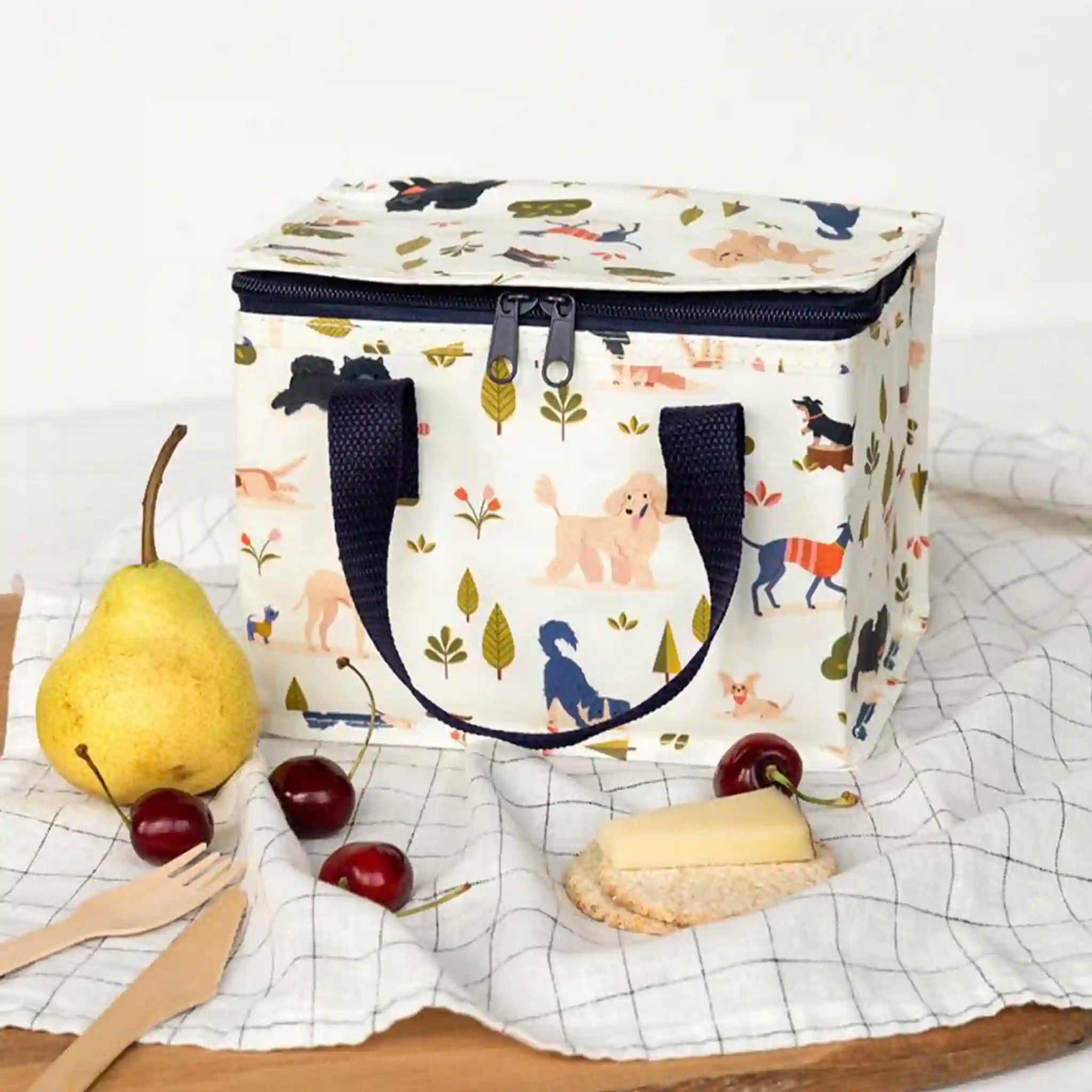  insulated lunch bag with animal pattern on a table with fruits and a pie