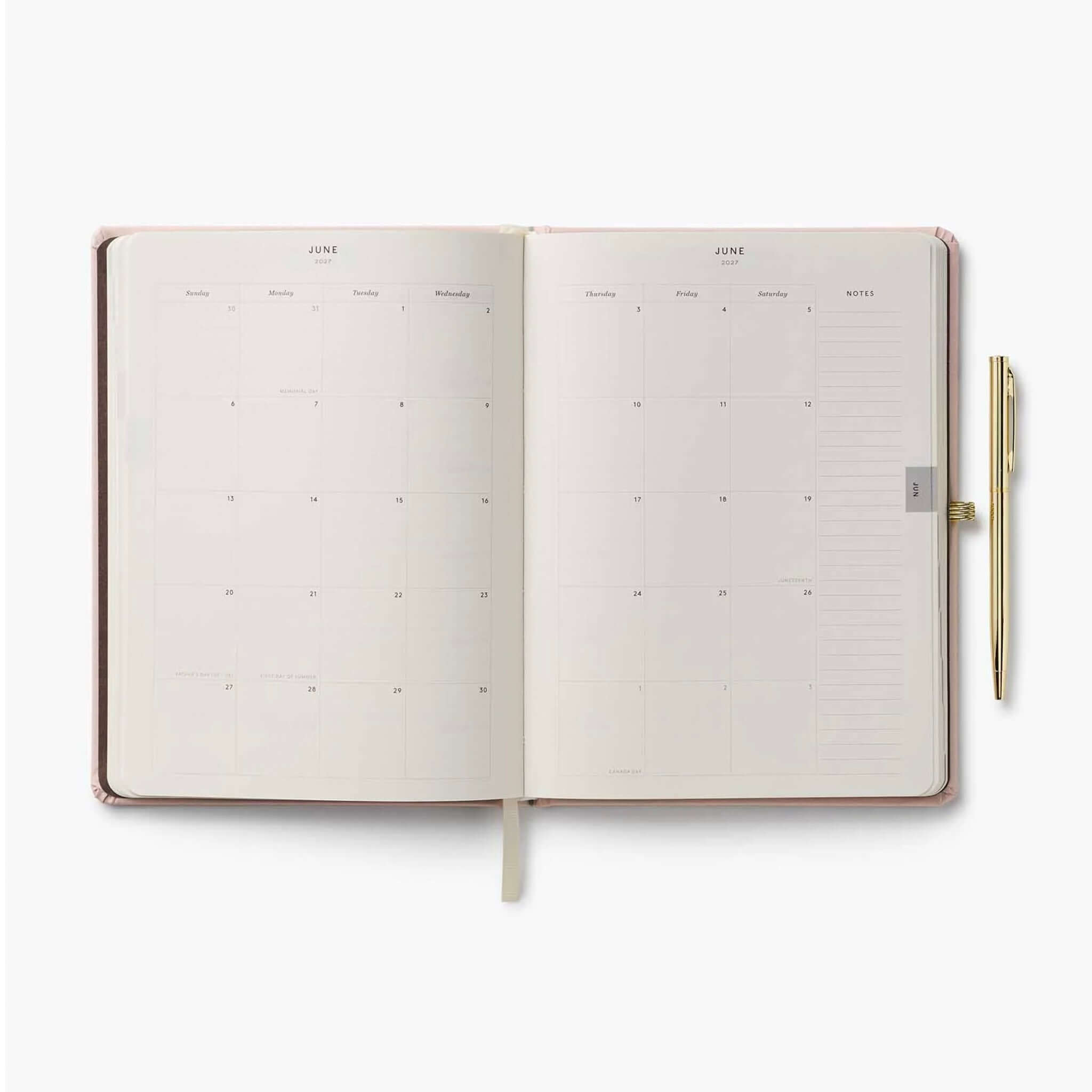 Rifle Paper 2027 Weekly Hardcover Planner with Pen - Paisley open to June month view with a gold pen.