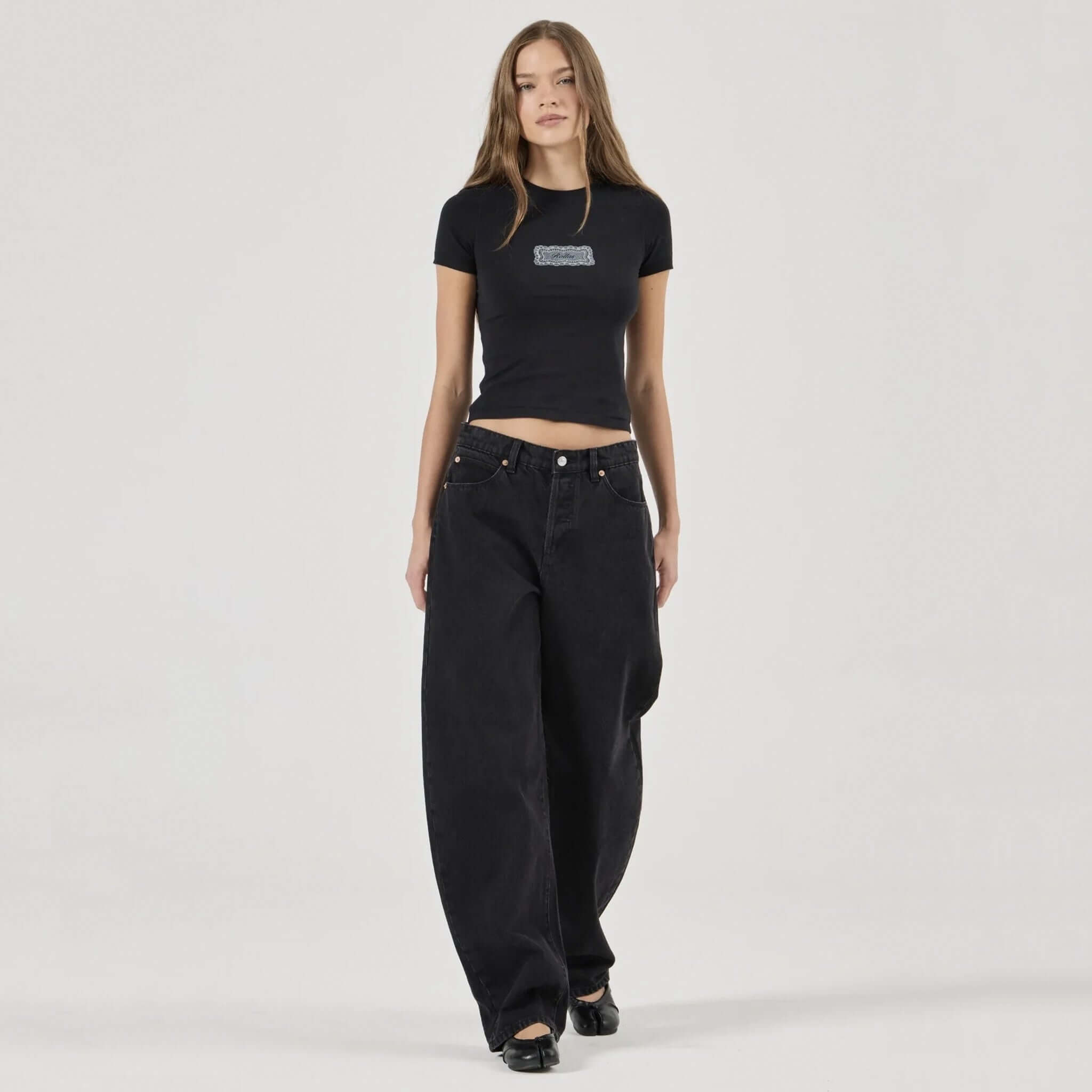 Alt Tag: Rolla's Arc Barrel Jeans - Black Sand on model, mid-rise relaxed barrel leg black cotton denim jeans front view